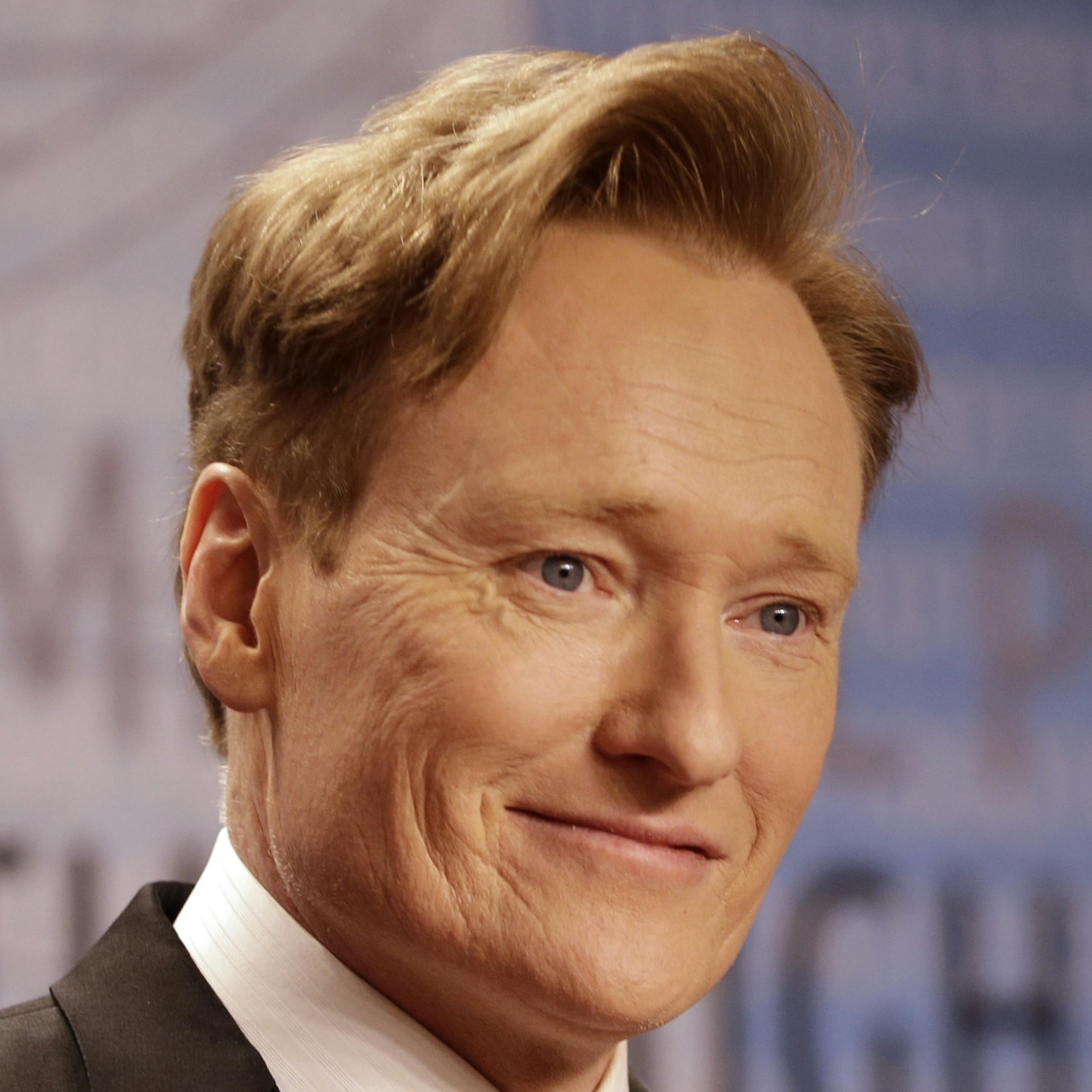 FILE - In this Dec. 12, 2013, file photo, talk show host Conan O'Brien arrives for the Breakthrough Prize in Life Sciences awards in Moffett Field, Calif. O'Brien announced Tuesday, March 4, 2014, on his TBS talk show "Conan" that he's hosting this year's MTV Movie Awards. The annual movie celebration that honors winners with popcorn-shaped trophies is scheduled for April 13, 2014 at the Nokia Theatre in downtown Los Angeles. (AP Photo/Ben Margot, file)