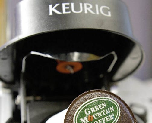 In this Oct. 7, 2010, file photo, a Green Mountain Coffee single-serving brewing cup is seen in a Keurig machine in Montpelier, Vt.