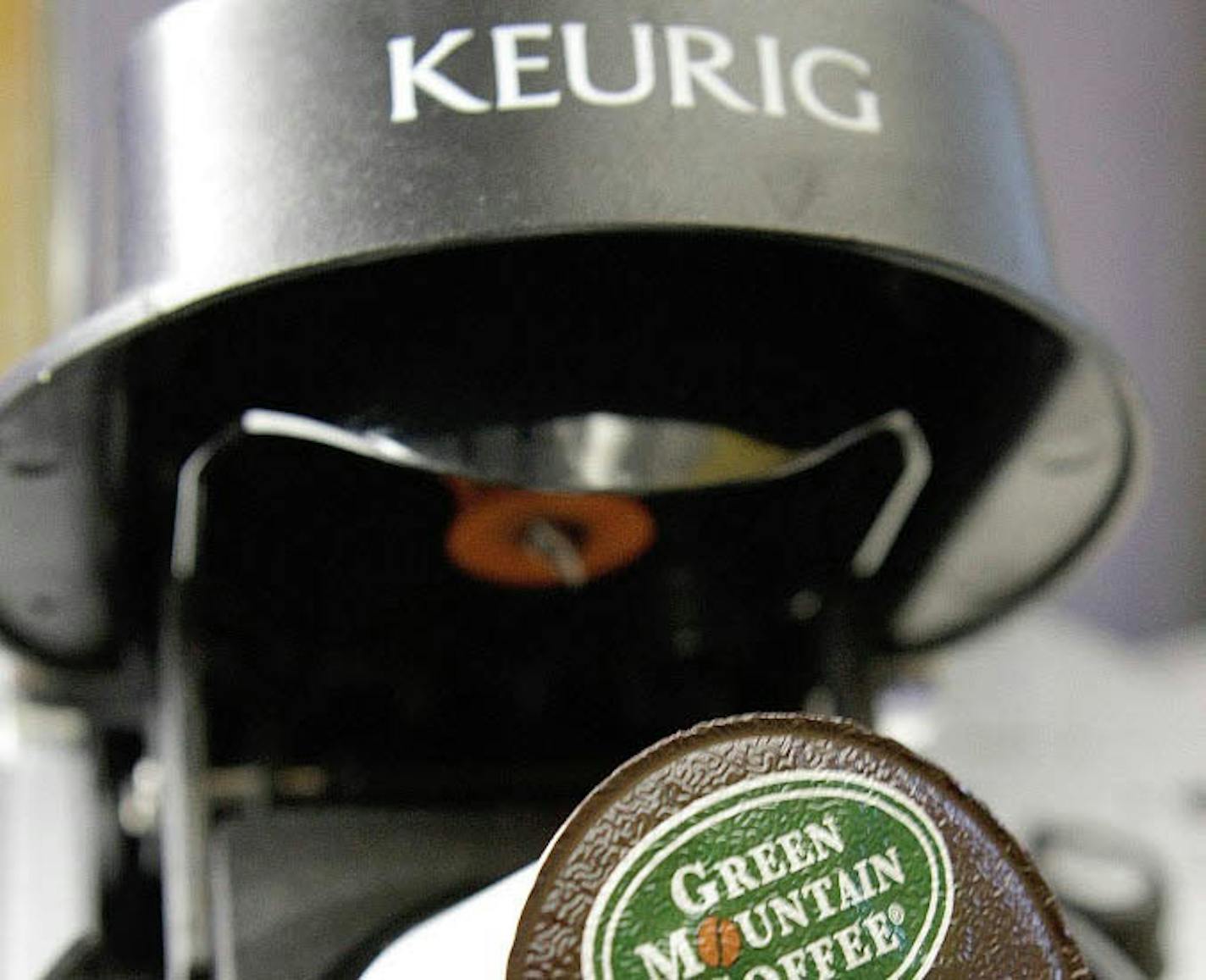 In this Oct. 7, 2010, file photo, a Green Mountain Coffee single-serving brewing cup is seen in a Keurig machine in Montpelier, Vt.