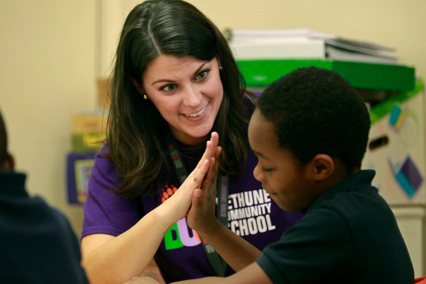 Jennifer Angell high-fived her first-grader after he followed directions on an assignment at Bethune Elementary School, Friday, December 19, 2014 in Minneapolis, MN. ] (ELIZABETH FLORES/STAR TRIBUNE) ELIZABETH FLORES � eflores@startribune.com