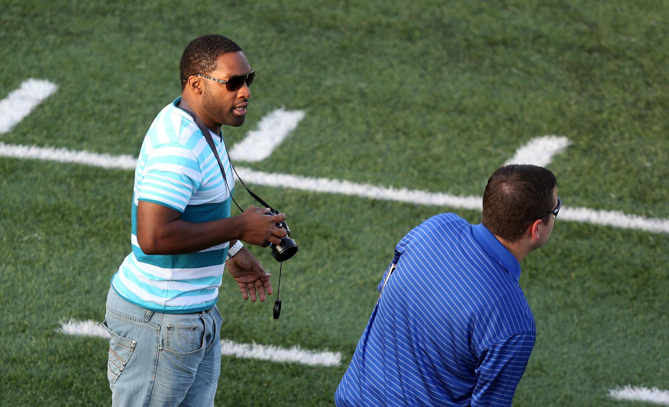 Levi Bradley walked the sidelines taking pictures during a game Chaska' played Chanhassen in Chanhassen Min., Friday, September 6, 2013. ] (KYNDELL HARKNESS/STAR TRIBUNE) kyndell.harkness@startribune.com
