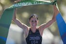 Gwen Jorgensen of St. Paul celebrated after crossing the finish line to win the women's triathlon ITU World Olympic Qualification Event in Rio de Jane