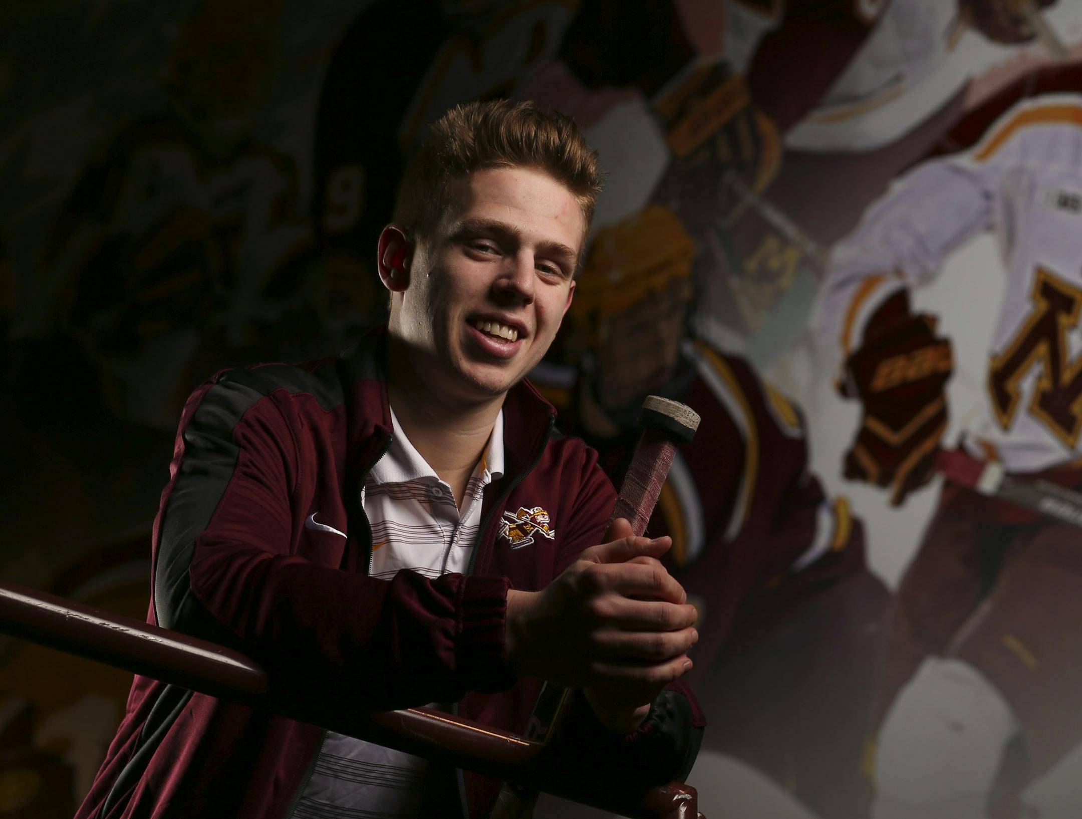 Gophers' junior defenseman Mike Reilly with the mural at Mariucci Arena where his image was added to the previous hockey All-America selections. ] JEFF WHEELER ï jeff.wheeler@startribune.com The Gophers' junior defenseman Mike Reilly is first team All-America and two-time Big Ten Defensive Player of the Year, photographed in front of the mural he's in at Mariucci Arena Wednesday afternoon, March 25, 2015. ORG XMIT: MIN1503251646314204