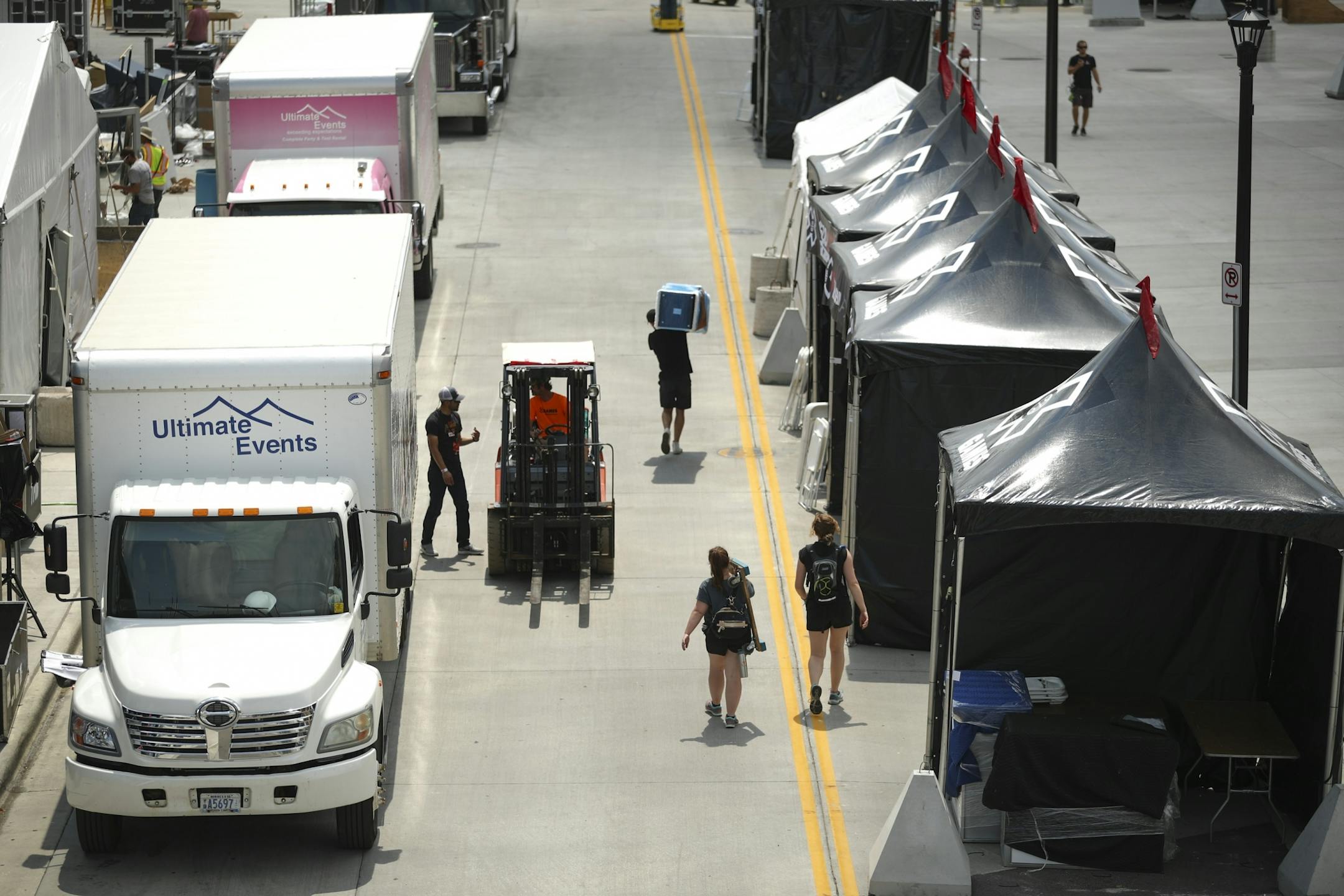 Workers set up tents on Chicago Ave. S. in front of U.S. Bank Stadium.