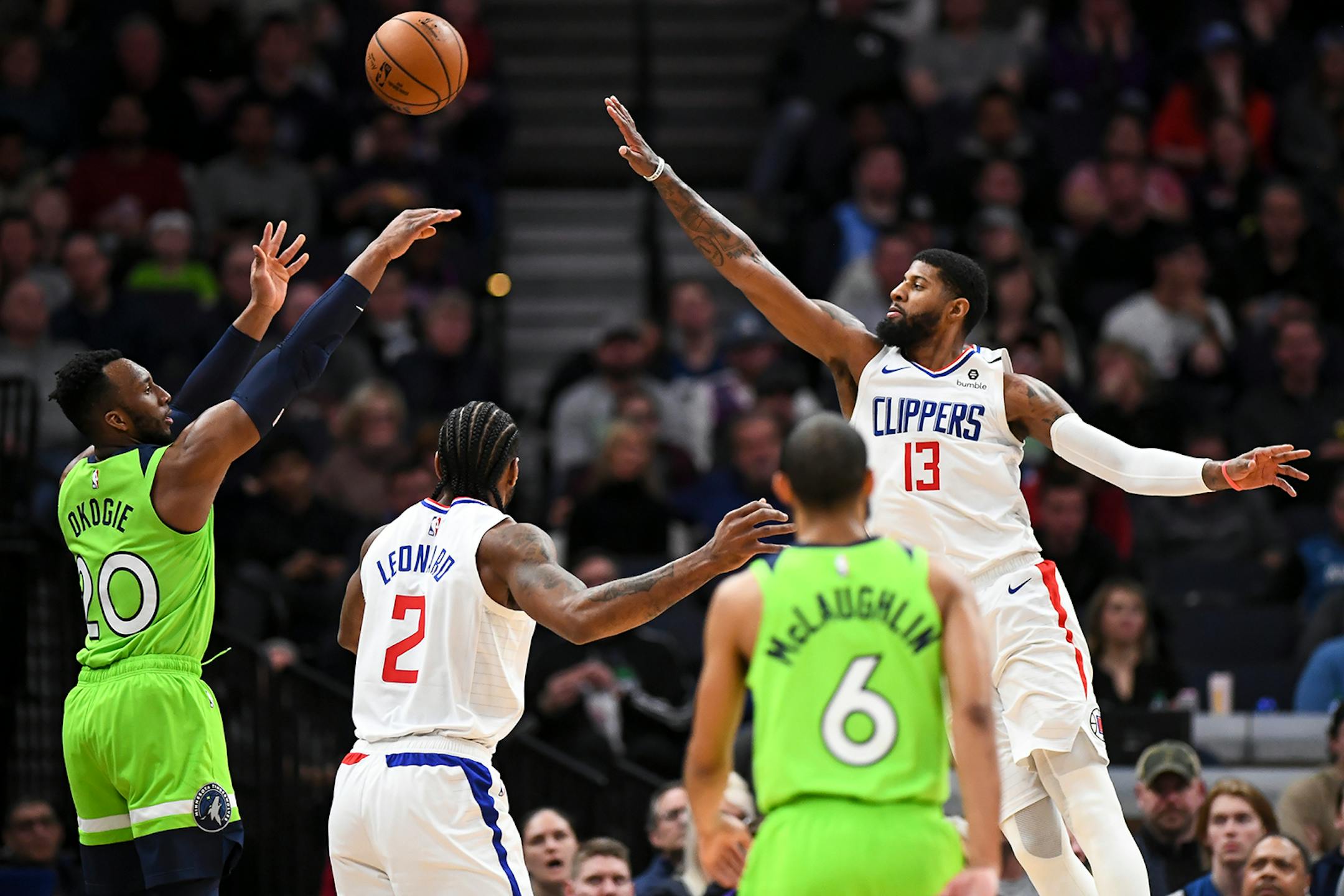 Minnesota Timberwolves guard Josh Okogie (20) hit a 3-pointer as he was defended by LA Clippers guard Paul George (13) in the second half.