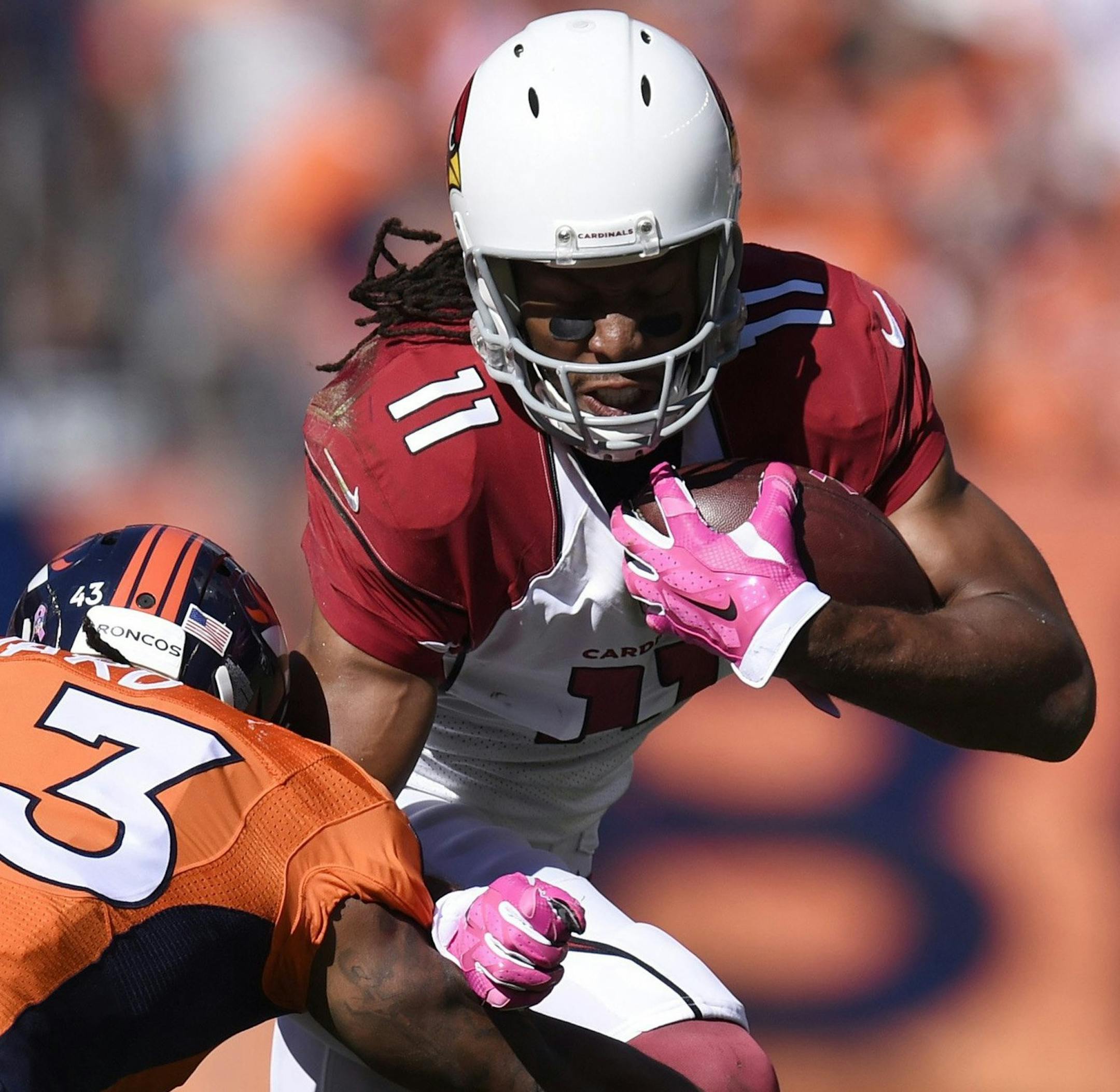 Broncos safety T.J. Ward stops Cardinals wide receiver Larry Fitzgerald in the first half of Denver's 41-20 win Sunday, Oct. 5, 2014 at Sports Authority Field at Mile High in Denver. (Mark Reis/Colorado Springs Gazette/MCT)