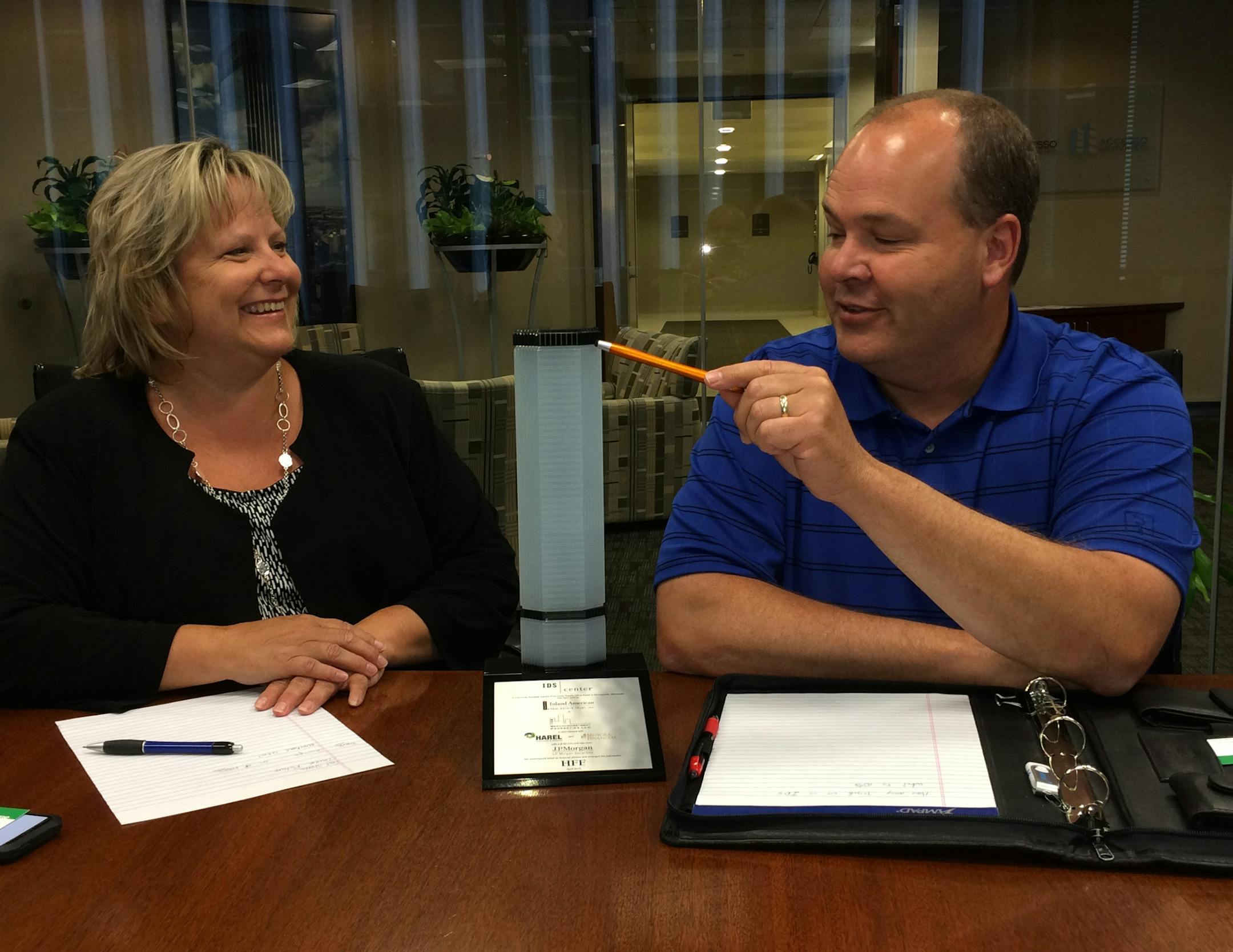 Deb Kolar, general manager of operations at the IDS Center and Mark Hancock, director of engineering services with the Center for Energy and Envionment, with a model of the IDS Center in Kolar's sixth-floor office.