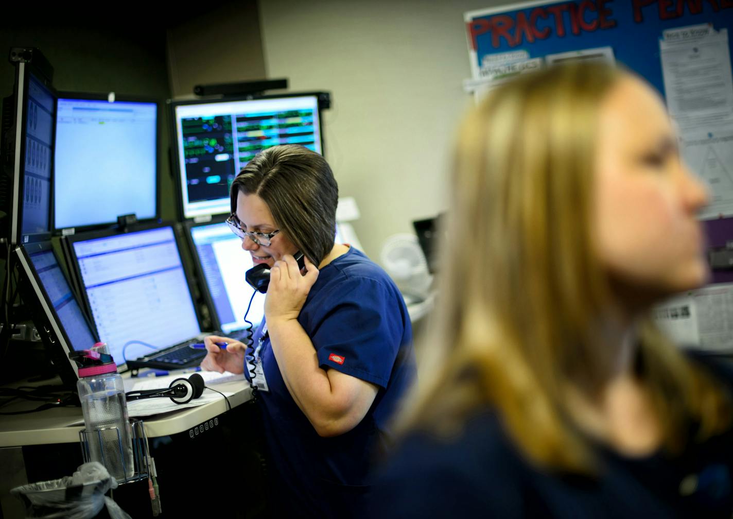 Inside the eICU: The Mayo eICU, or electronic intensive care unit, currently monitors 73 ICU beds in southern Minnesota and portions of Iowa and Wisconsin. Above, RN Jennifer Meindel made a call to a doctor in one of the participating ICUs.