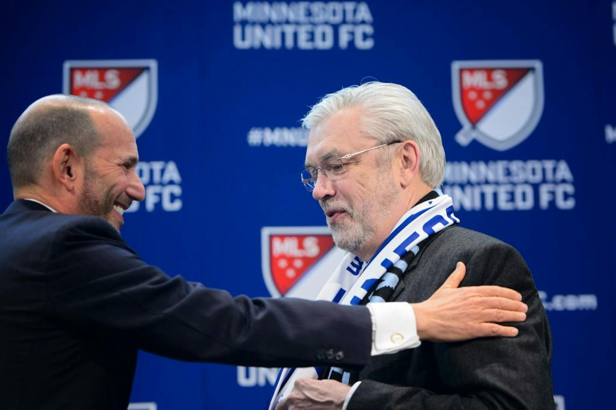 Major League Soccer Commissioner Don Garber, left, and Dr. Bill McGuire, current owner of the Minnesota United club in the second-tier North American Soccer League, chat during a news conference, Wednesday, March 25, 2015, in Minneapolis, where they announced that Minnesota will be awarded an MLS franchise. (AP Photo/Star Tribune,Glen Stubbe) MANDATORY CREDIT; ST. PAUL PIONEER PRESS OUT; MAGS OUT; TWIN CITIES LOCAL TELEVISION OUT