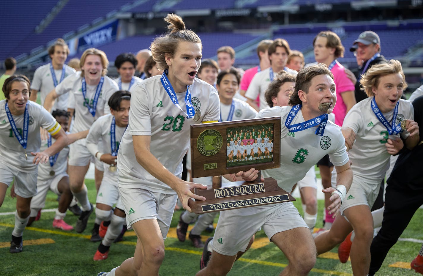 Hill-Murray's Ronan O'Connor, left, and Jude Bonin hefted the hardware after the Pioneers defeated Orono for the Class 2A title Friday. 3-0 for the Championship title in the 2023 Minnesota High School State Soccer Tournament in the AA division at US Bank Stadium in Minneapolis, Minn., on Friday, Nov. 03, 2023. ] Elizabeth Flores • liz.flores@startribune.com