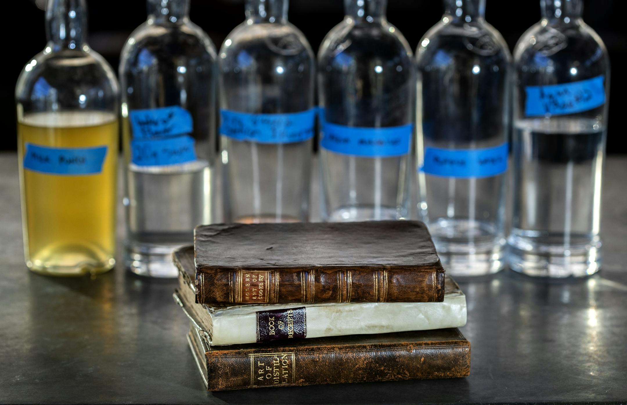 Historical books with food and drink recipes. Top Ð Modern Art of Cookery Improved or Elegant, Cheap and Easy Methods of preparing moft of the Dishes in Vogue, Ann Shackleford, 1767. Middle Ð Book of Receipts, Ann Ward, c. 1724. Manuscript. Bottom Ð Art of Distillation.