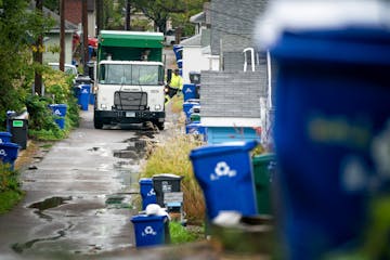 Waste Management worker Daniel Westerhaus collected trash from the alleys of the Snelling Hamline neighborhood of St Paul’s yellow zone on the first