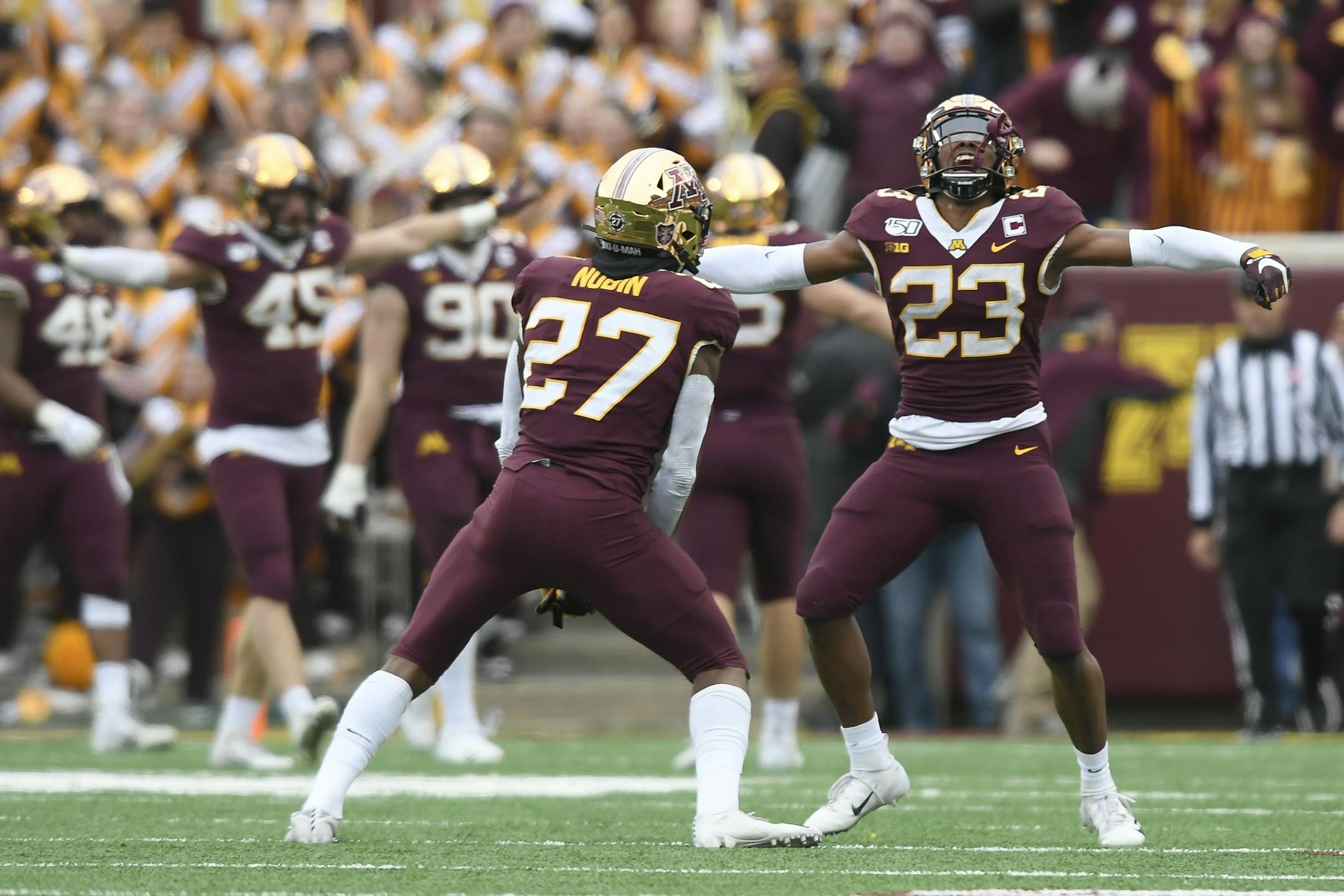Minnesota Gophers defensive back Jordan Howden (23) and defensive back Tyler Nubin (27) celebrated after a turnover on downs against the Penn State Nittany Lions in the fourth quarter.