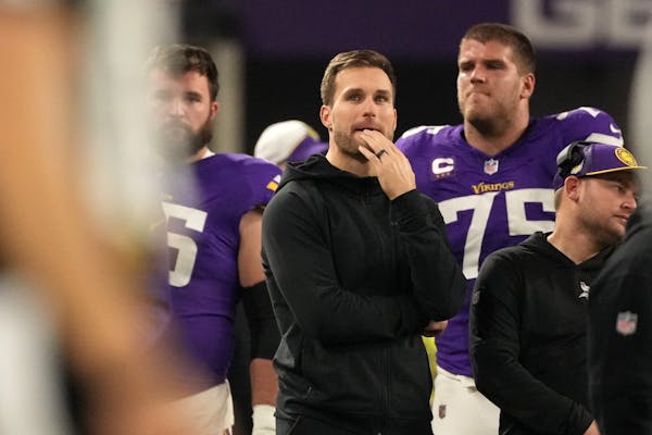 Injured quarterback Kirk Cousins watched from the sideline as the Vikings played the Packers on Dec. 31, 2023, at U.S. Bank Stadium.
