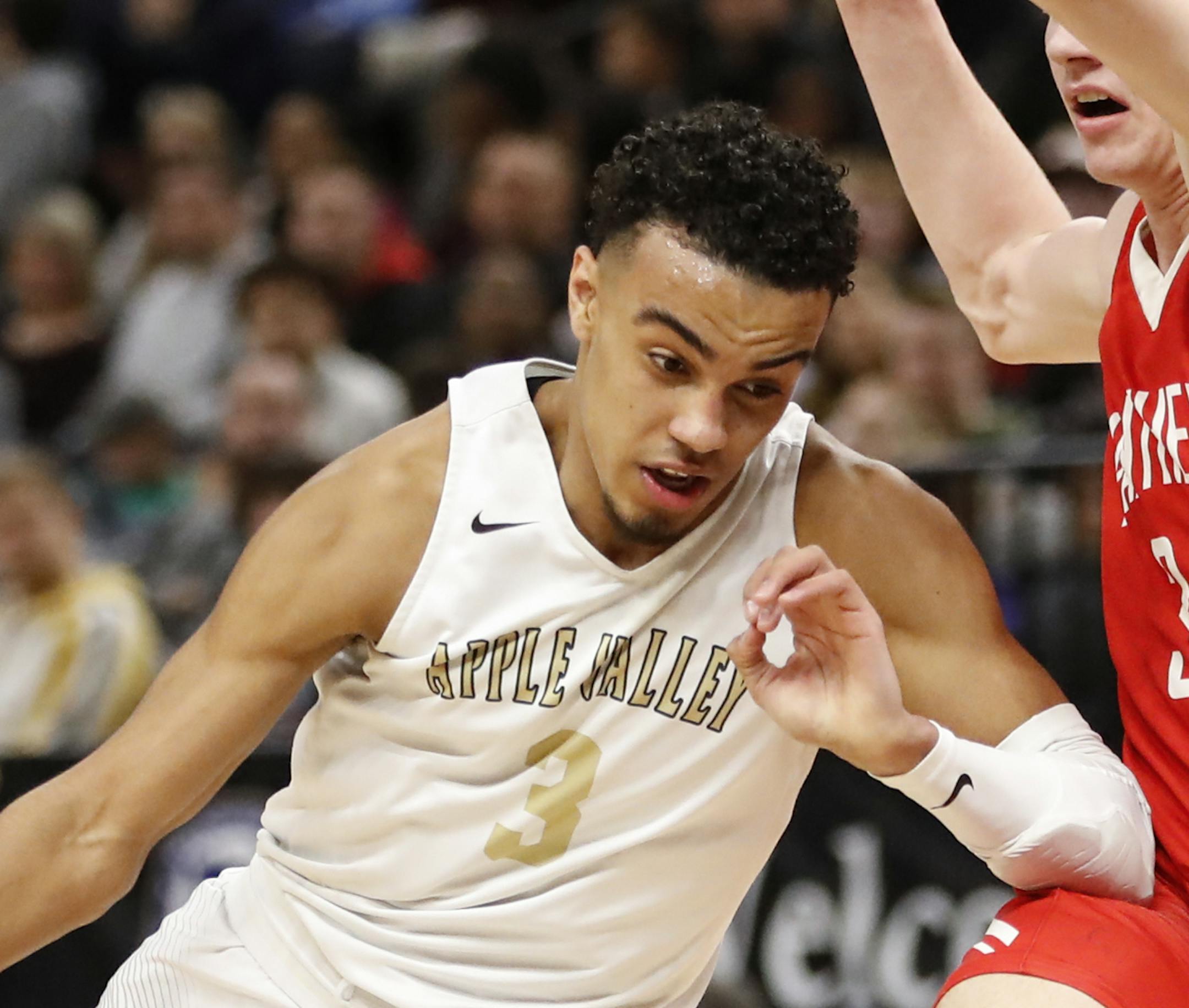 In this March 22, 2018 photo, Apple Valley guard Tre Jones (3) dribbles alongside Lakeville North guard Tyler Wahl (31) during the semifinals of the Class 4A boys high school basketball tournament at Target Center in Minneapolis. Just like his older brother Minnesota Timberwolves star Tyus Jones, Tre Jones has closed his high school basketball career at Apple Valley as a repeat Associated Press Player of the Year award winner. (Renee Jones Schneider/Star Tribune via AP)