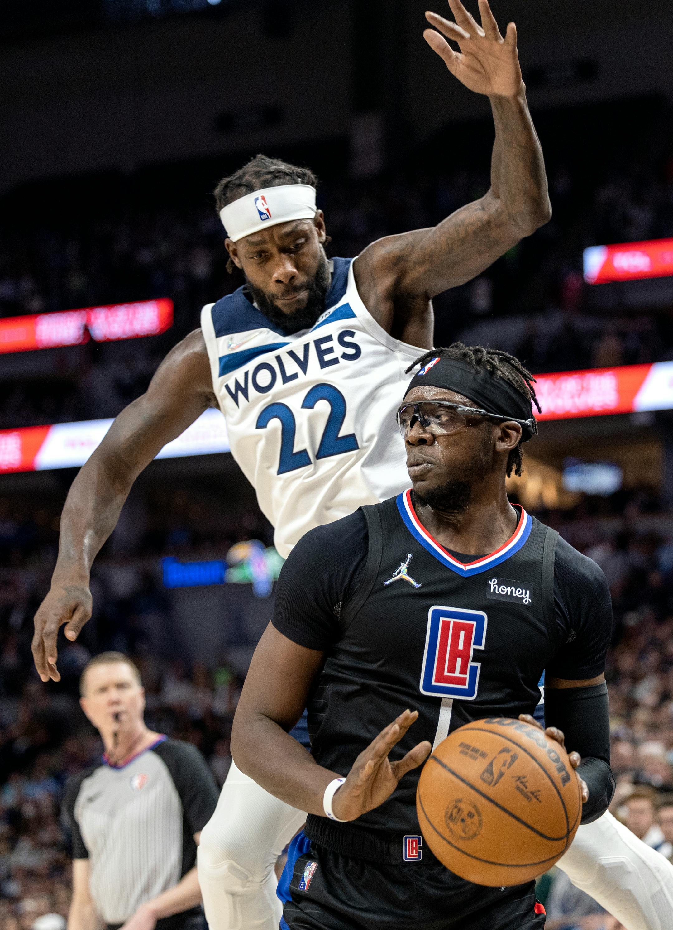 Reggie Jackson (1) of the Los Angeles Clippers is defended by Patrick Beverley (22) of the Minnesota Timberwolves in the first quarter.