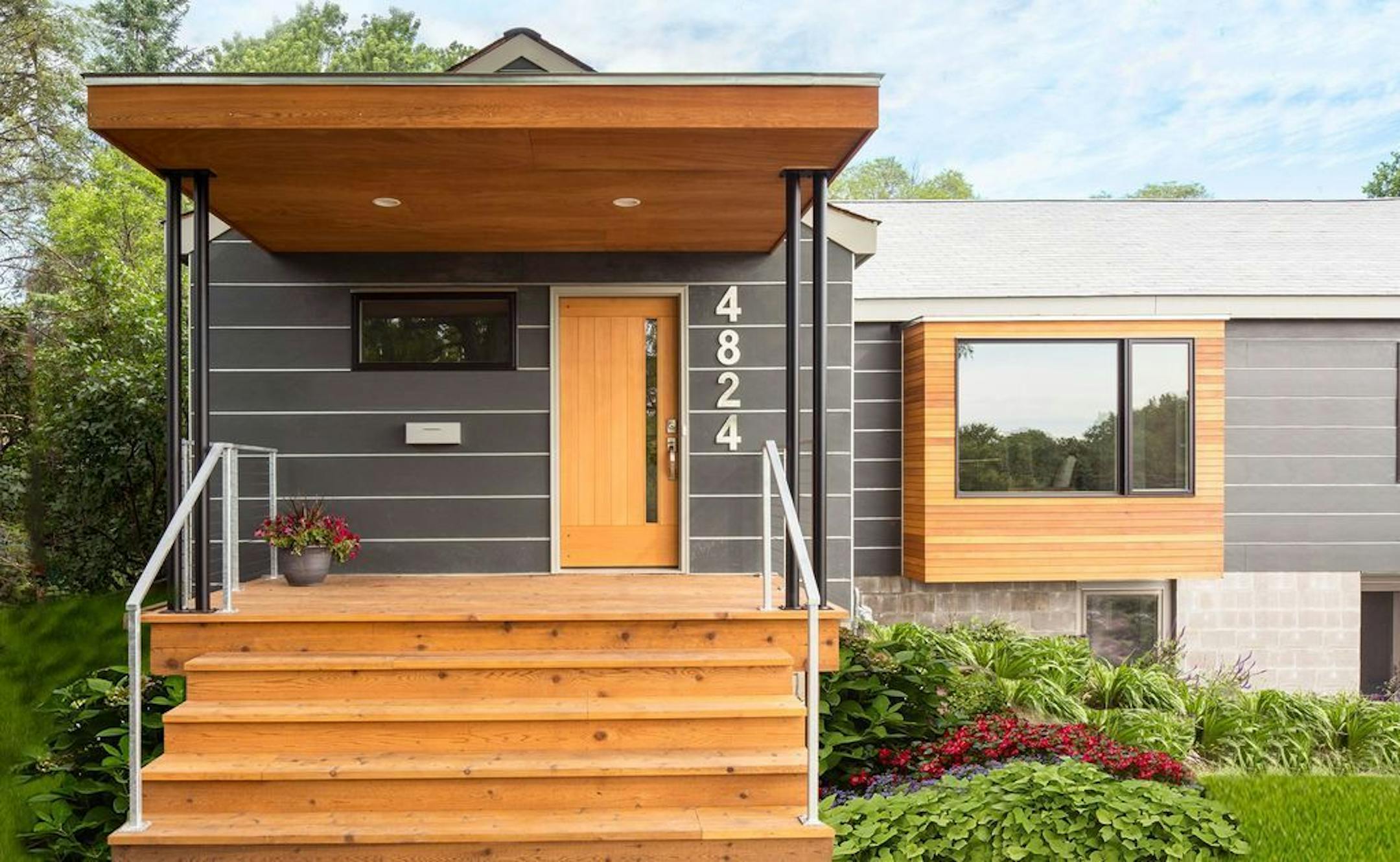 The sheltered front porch is an additional outdoor sitting area. The exterior is a combination of cedar and James Hardie fiber cement siding.