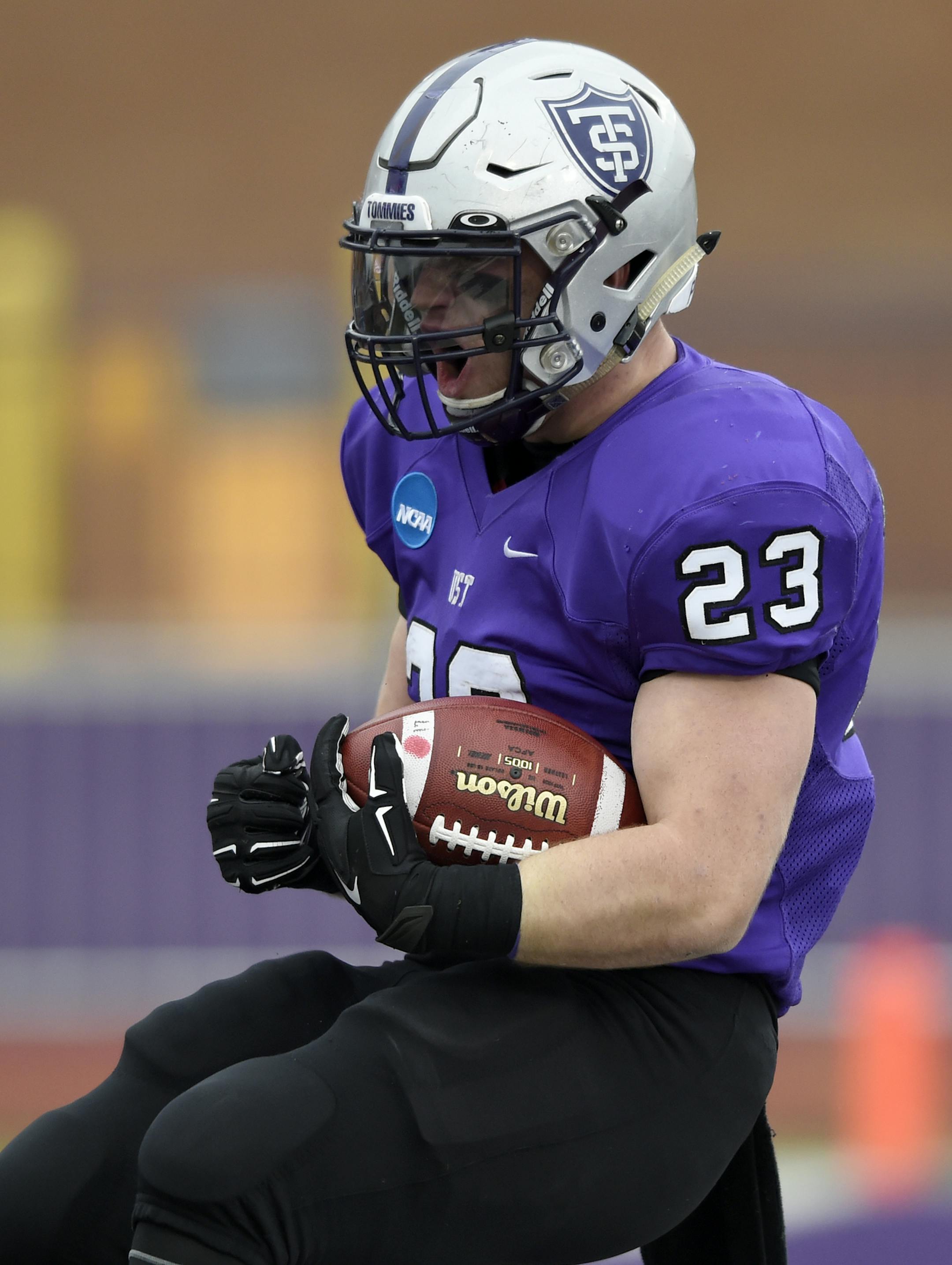 St. Thomas running back Jordan Roberts (23) celebrates scoring a touchdown against the Linfield during the first quarter during a Division III NCAA college football semifinal game on Saturday, Dec. 12, 2015, in St. Paul, Minn. St. Thomas won 38-17. (AP Photo/Hannah Foslien)