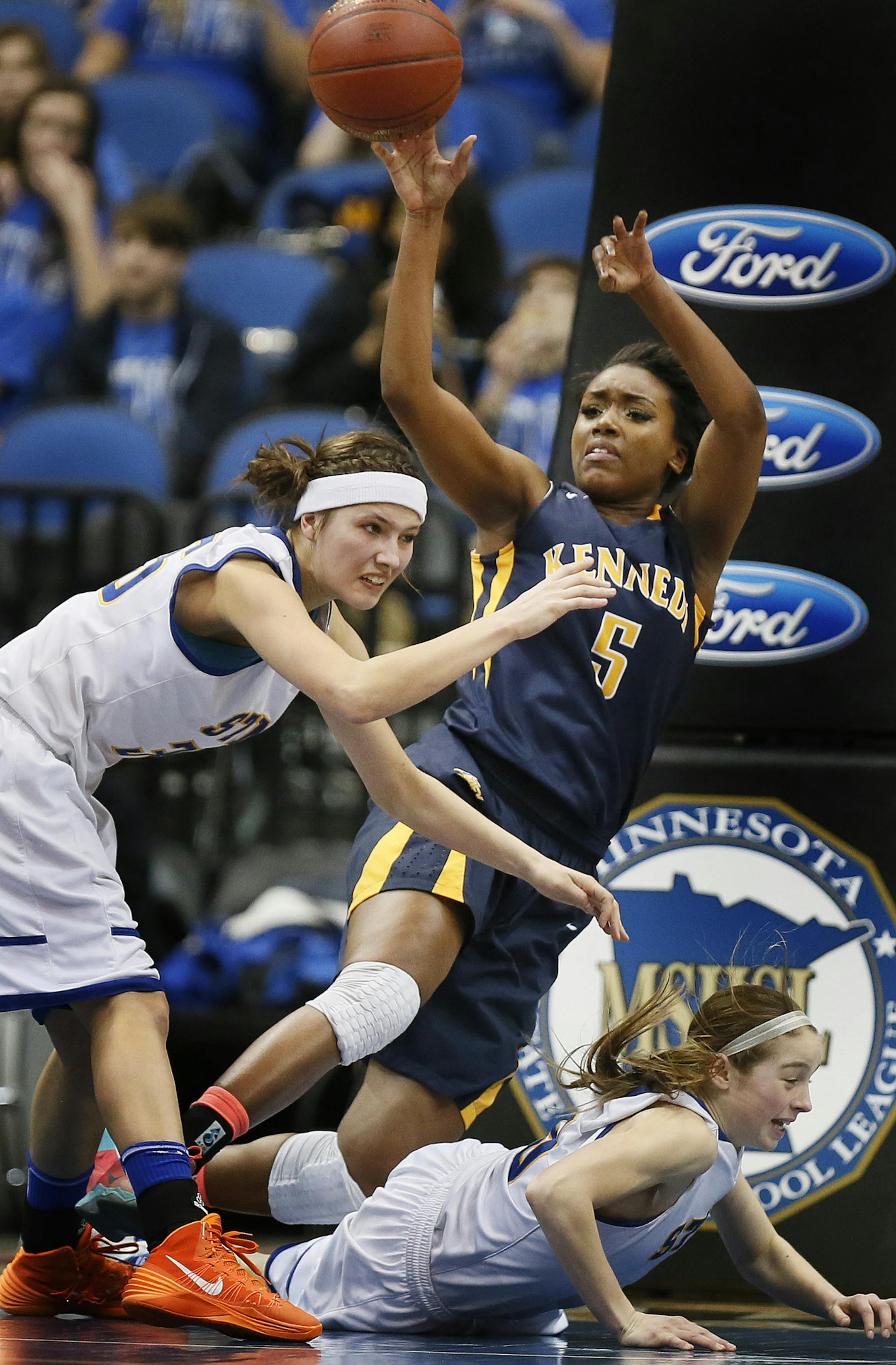 Tonoia Wade of Kennedy passed the ball over Erin Autio left and her teammate Lizzy Heilduring 4-A girls quarter final action at Target Center between Bloomington Kennedy Eagles and St. Michael- Albertville Nights Tuesday March 18, 2014 in Minneapolis,MN.] JERRY HOLT jerry.holt@startribune.com