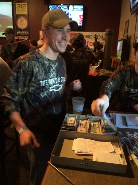 Trent Seamans, a University of Minnesota student, handled cash at the door of his Ducks Unlimited banquet last week at a St. Paul tavern. The Universi