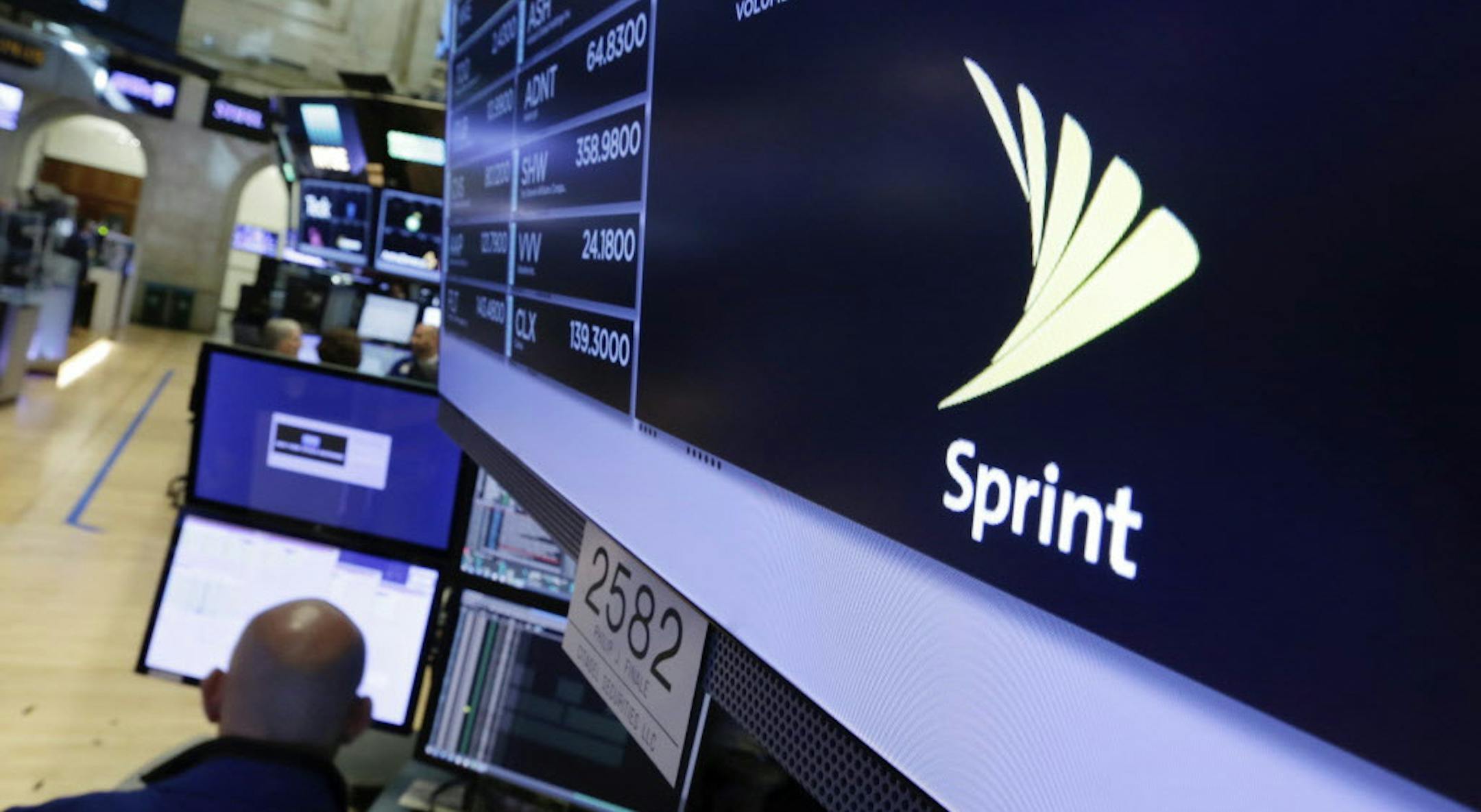 The Sprint logo appears above a trading post on the floor of the New York Stock Exchange, Tuesday, June 27, 2017. Sprint climbed 5.8 percent following a published report suggesting the mobile phone company is in talks with Charter Communications and Comcast Corp. on a deal that could enable the cable operators to buy a stake in Sprint. (AP Photo/Richard Drew)