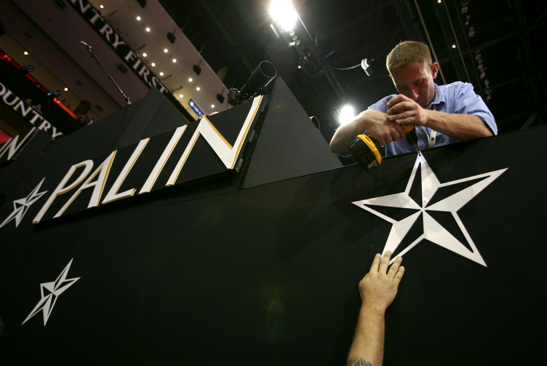 Some finishing touches were put on a sign Monday for vice presidential candidate Gov. Sarah Palin before the start of the opening session of the convention. Delegates know that ­Palin's résumé is thin, but it didn't seem to matter to most.