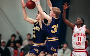 Sean Sweeney, middle, works for a rebound with Cretin-Derham Hall teammate Joe Mauer against Highland Park's Maurice Hargrow on Feb. 13, 2001, helping