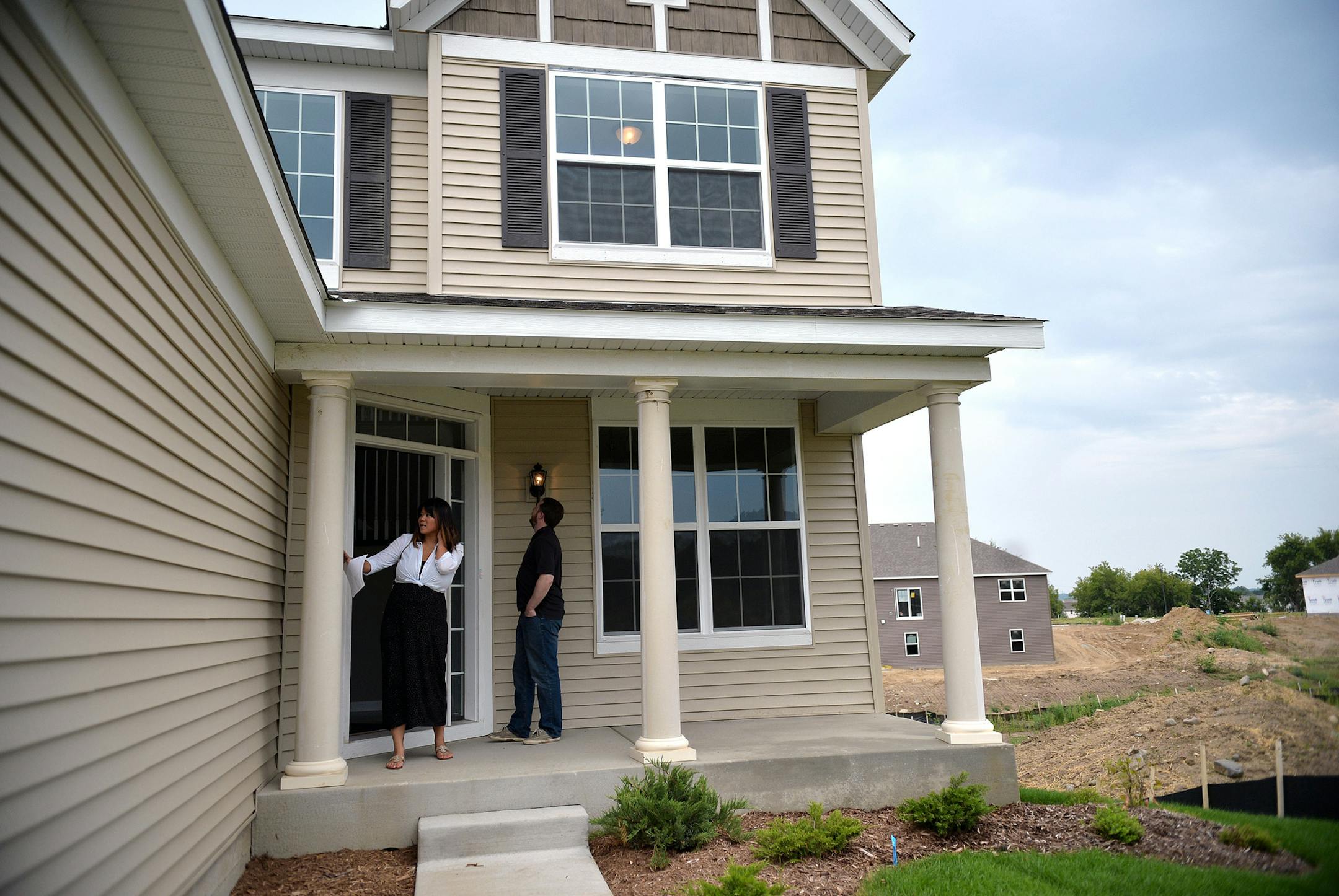 Nate and Linda Rose, both 32, tour a new-construction home in Shakopee's Dakota Crossing with Edina Realty Real Estate Agdent, Derek Jopp. ] (SPECIAL TO THE STAR TRIBUNE/BRE McGEE) **Nate Rose (32, right), Linda Rose (32, left), Derek Jopp (not pictured, Real Estate Agent)