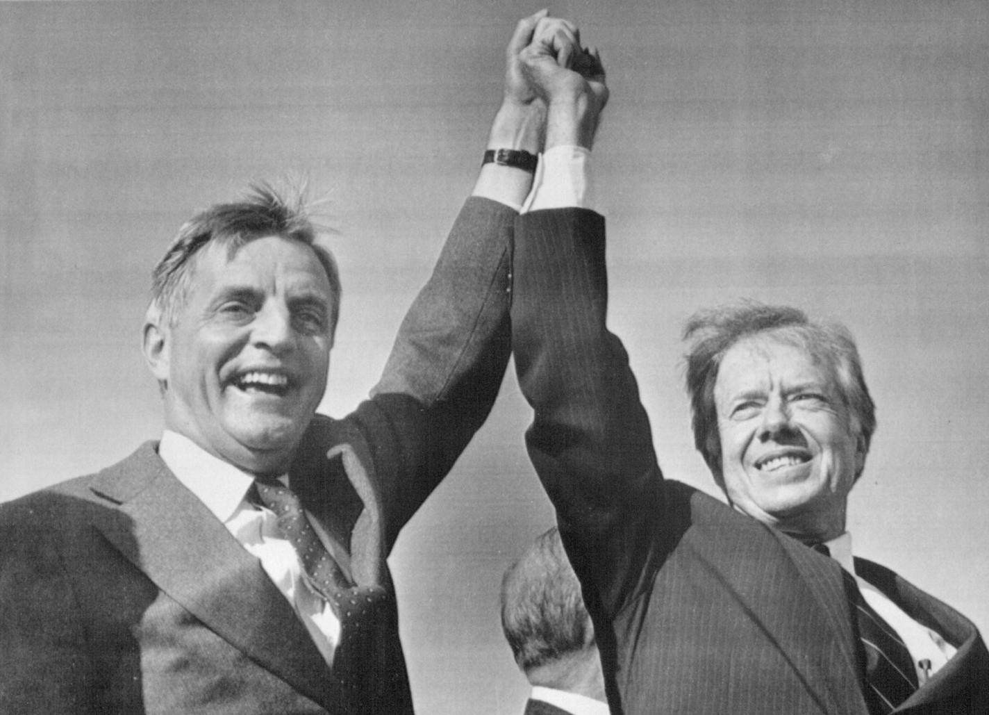 November 3, 1980 CO-CAMPAINERS -- President Jimmy Carter (right) and Vice-President Walter Mondale share a victory salute at the Akron-Canton Municipal Airport Monday. They addressed a rally of about 4,000 people before taking off for another campaign tip. November 4, 1980 JW, AP Laserphoto