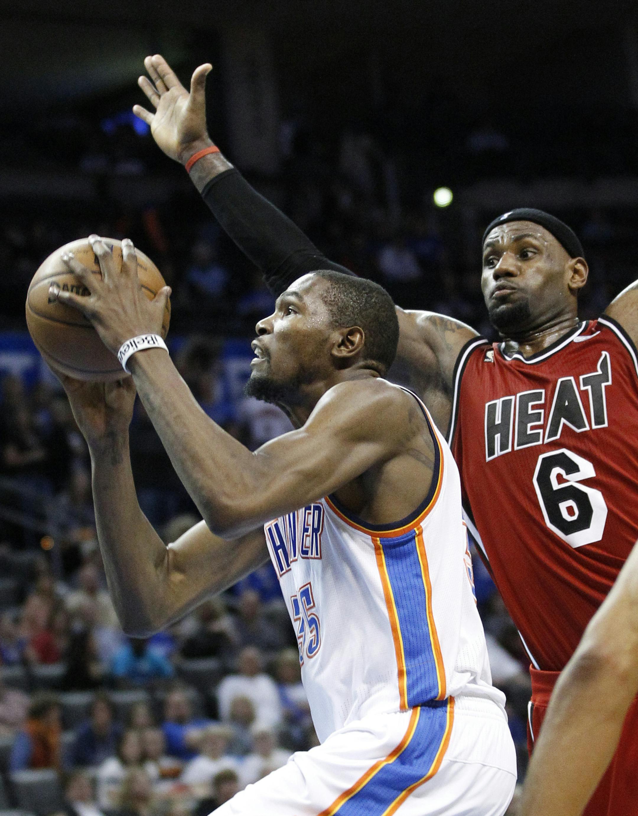FILE - In this Feb. 14, 2013, file phot, Oklahoma City Thunder forward Kevin Durant (35) shoots in front of Miami Heat forward LeBron James (6) during NBA basketball game in Oklahoma City, It's a matchup of perhaps the best two players in the NBA, when James and Durant square off on Wednesday night, Jan. 29, in Miami.(AP Photo/Sue Ogrocki, File)