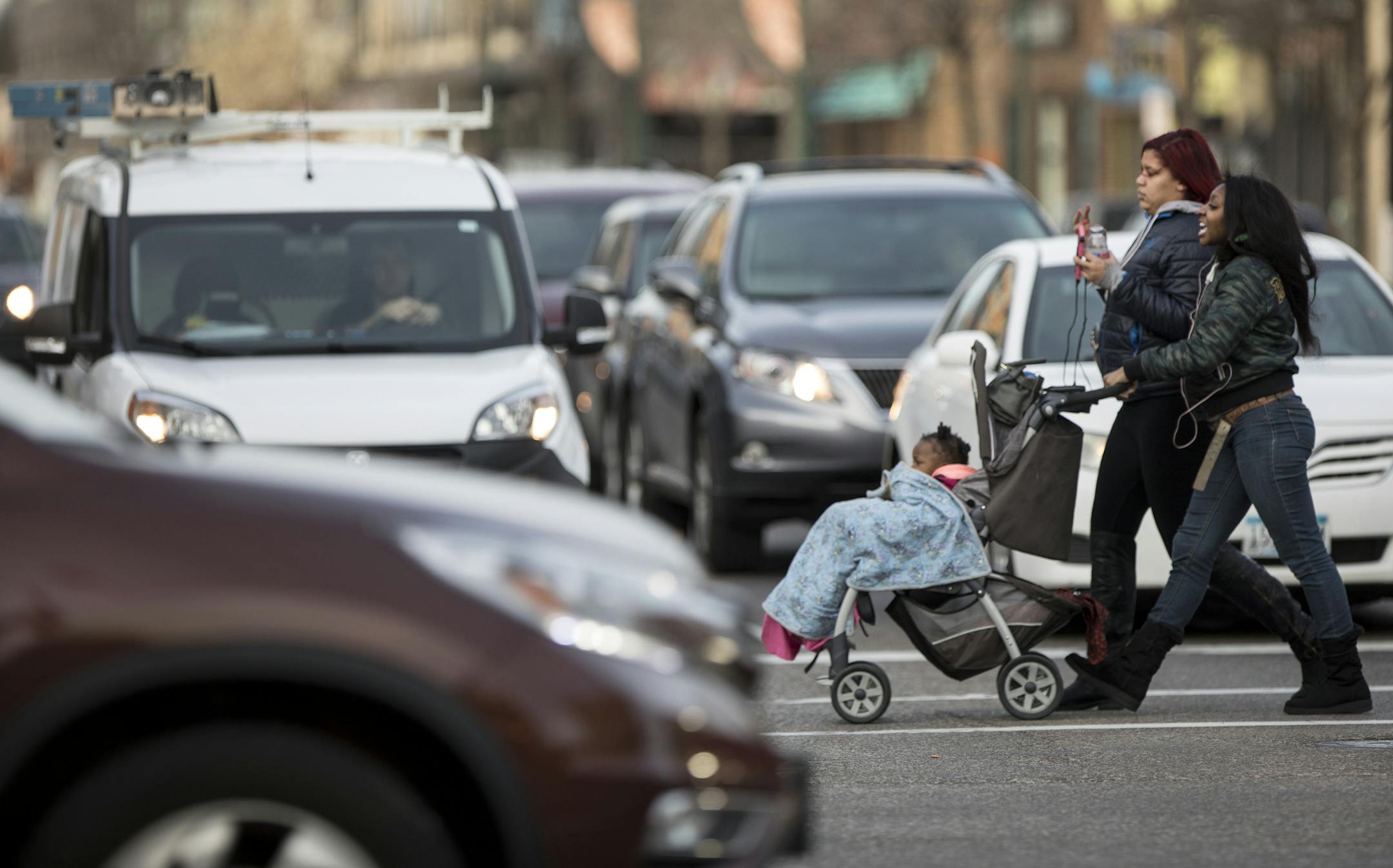 Chania Addison, right, walked with her cousin Alexis Newmann as she pushed her daughter Golden Addison in a stroller while shopping in Uptown at the intersection of Lyndale Avenue and Lake Street on Wednesday, November 29, 2017. ] RENEE JONES SCHNEIDER &#x2022; renee.jones@startribune.com