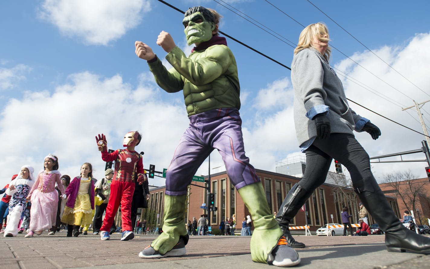 Keaton Maros, 6, of Ramsey, walked with his mother, Michele, during Friday's parade in Anoka. ] (AARON LAVINSKY/STAR TRIBUNE) aaron.lavinsky@startribune.com Local school children walk on Main Street in their festive Halloween costumes as part of Anoka's halloween tradition on Friday, Oct. 30, 2015.