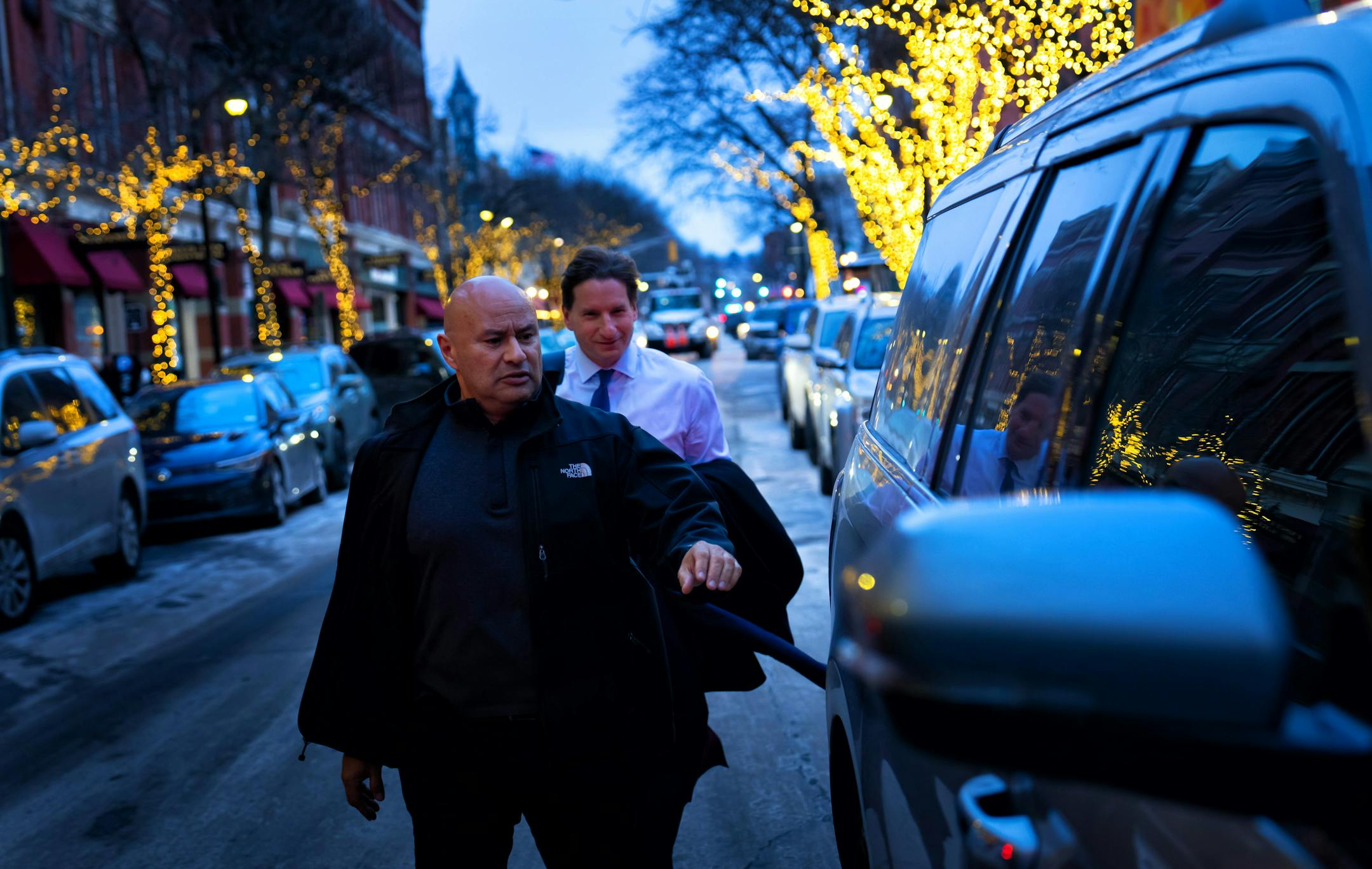Outside his New Hampshire campaign headquarters, Dean Phillips’ security man “Nacho” escorted Phillips into his campaighn vehicle on the way to a campaign stop  Friday, Jan. 19, 2024  Manchester, New Hampshire.    ] GLEN STUBBE • glen.stubbe@startribune.com