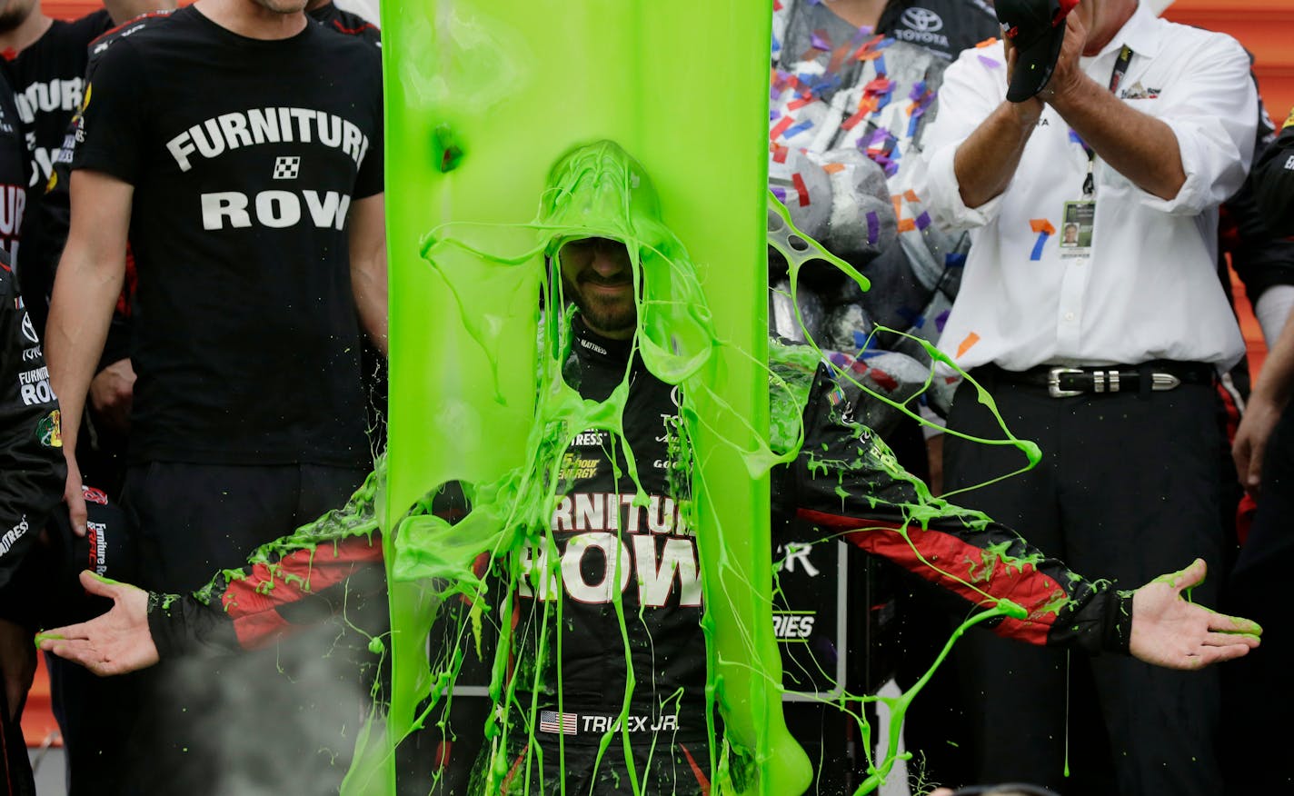 Martin Truex Jr. celebrates with his crew in Victory Lane after winning a NASCAR Cup Monster Energy Series auto race at Chicagoland Speedway in Joliet, Ill., Sunday, Sept. 17, 2017. (AP Photo/Nam Y. Huh)