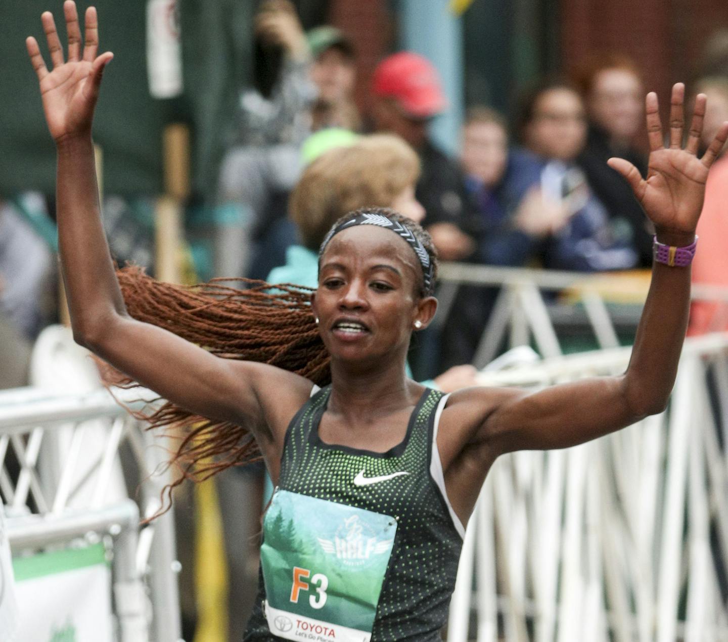 t061618 --- Clint Austin --- 061718.N.DNT.GMAS.C46 --- Monicah Ngige of Lansing, Mich. celebrates while crossing the finish line of Garry Bjorklund Half Marathon in the Canal Park neighborhood of Duluth Saturday morning. Ngige was the female winner with a time of 1:09:55 --- Clint Austin / caustin@duluthnews.com