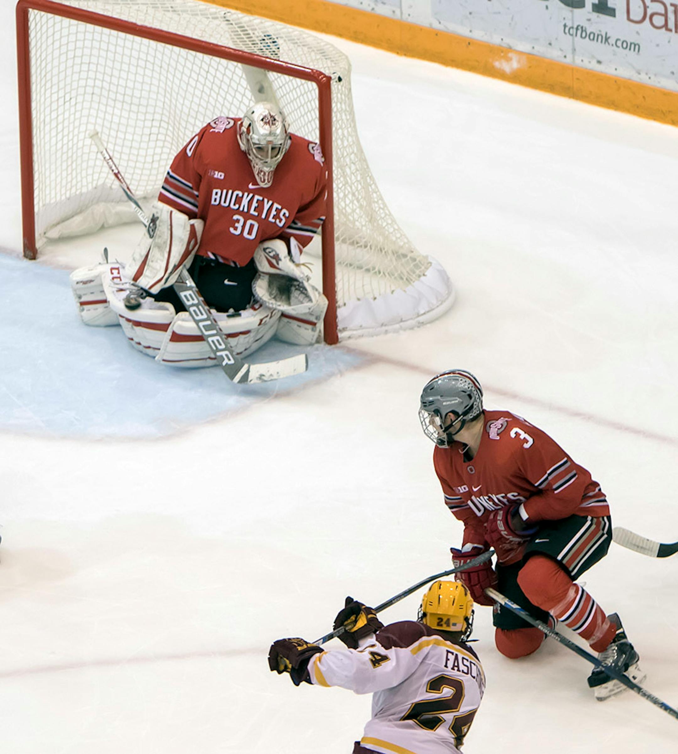 Minnesota Golden Gophers forward Hudson Fasching (24) scores the game winning overtime goal as the puck goes in the far side of the goal past Ohio State Buckeyes goalie Christian Frey (30) as the Minnesota Golden Gophers hosted the Ohio State Buckeyes to open the Big Ten Conference schedule on December 4, 2015. ] Special to Star Tribune MATT BLEWETT ï matt@mattebphoto.com - December 4, 2015, Minneapolis, MN, Big Ten Hockey, Minnesota Golden Gophers vs. Ohio State Buckeyes, 257622 UPUK 120415