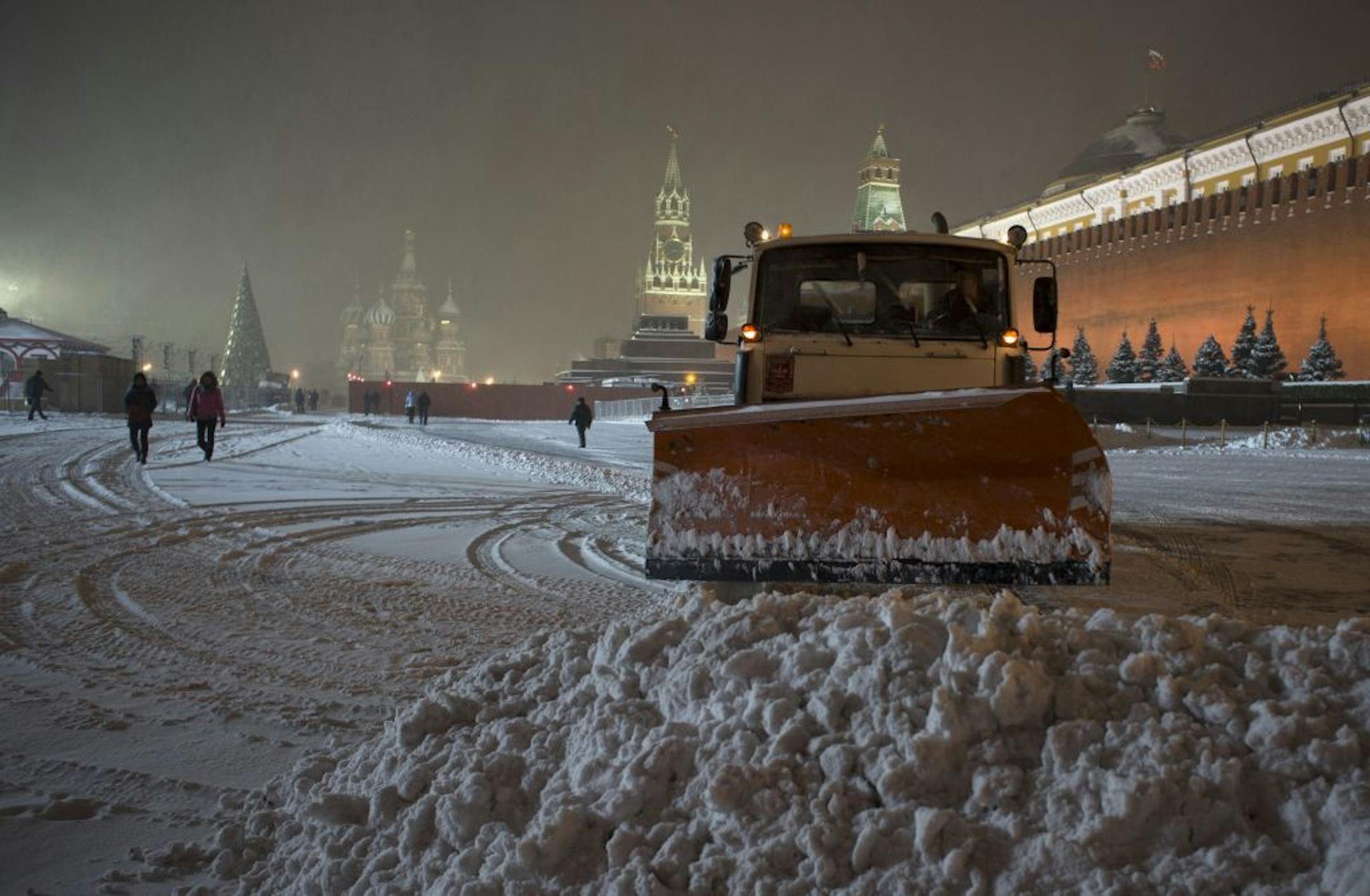 A bulldozer removes snow in Red Square in Moscow, Russia, early Thursday, Nov. 29, 2012. A snowfall hit Moscow on Wednesday with temperatures falling to about 0 degrees Centigrade (32 degrees Fahrenheit) .