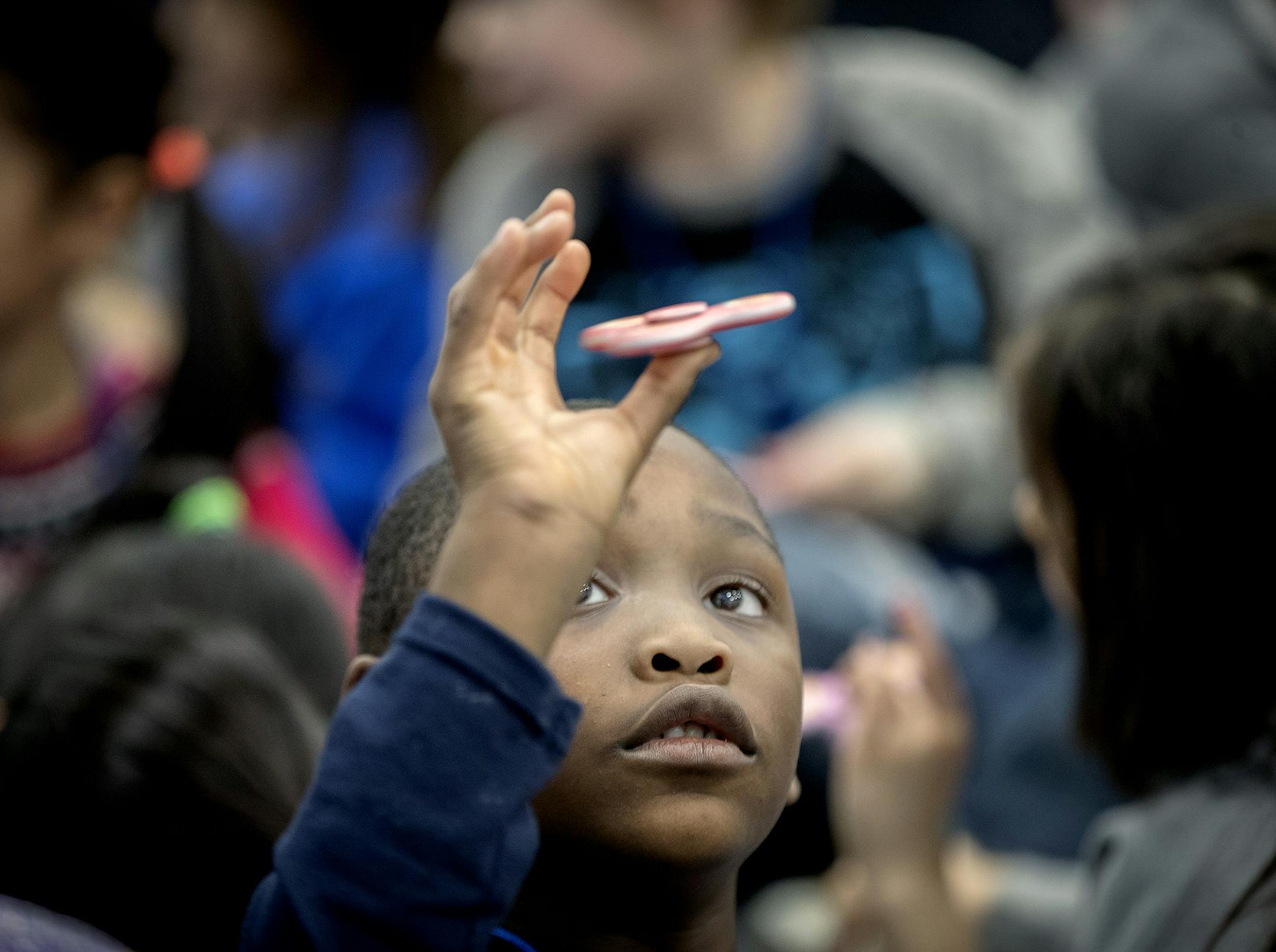 Monroe Elementary School first-grader Korbin Walton practiced spinning before he joined more than 650 students at the school as they attempted to set a world record with fidget spinners, Thursday, December 21, 2017 in Brooklyn Park, MN. ] ELIZABETH FLORES ï liz.flores@startribune.com