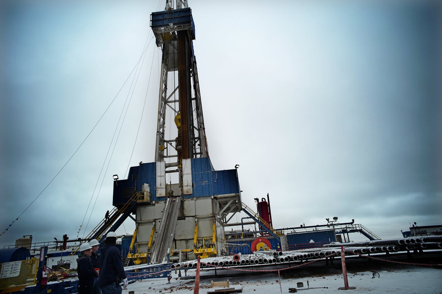 A rig was drilling three new wells in North Dakota in this file photo. Oil and gas production broke another record in July in the state. (Richard Tsong-Taatarii/Star Tribune)