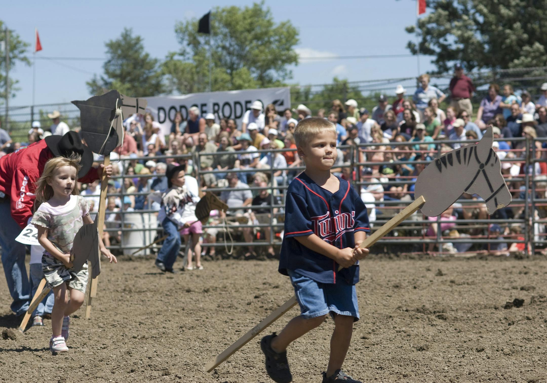 m.k. smith - mksmith@startribune.com - Corcoran, Minn 07112008 ] The annual Hamel Rodeo hosted family day on July 12, 2008 in Corcoran, Minn. Familes from around Minnesota arrived to watch bull riding, roping and have the kids participate in stick pony races among other games and events. Pictured: And they're off, young cowboys and cowgirls race from one end of the arena and back in the stick pony race for kids seven and under. ORG XMIT: MIN2013070316292150