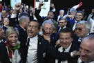 Mayor of Milan Giuseppe Sala, second left, and members of Milan-Cortina delegation celebrate after winning the bid to host the 2026 Winter Olympic Gam
