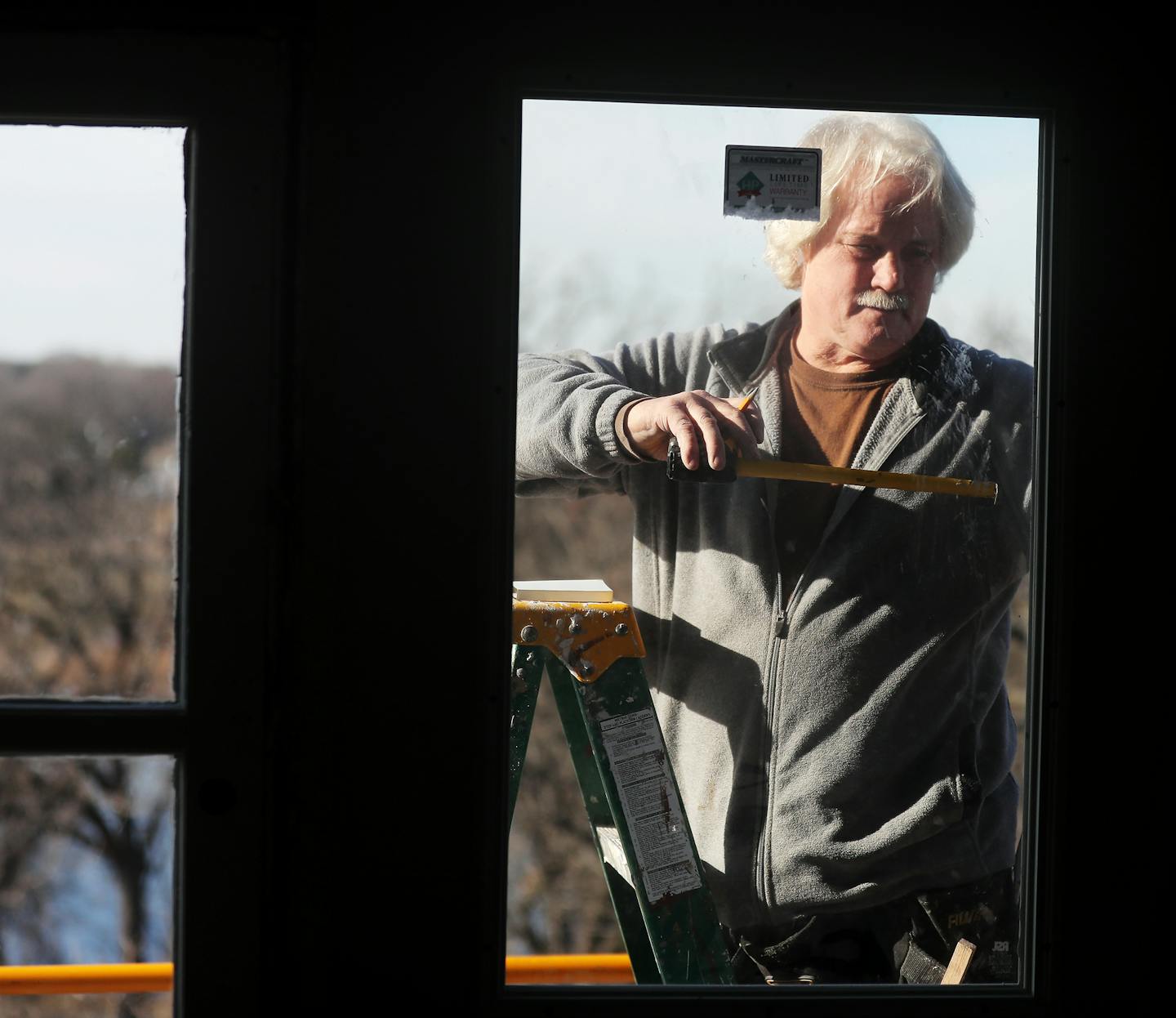 Bob Malarkey of Champlin checked a new window. Nearly everything had to be updated with lightning speed to get the place ready by winter.