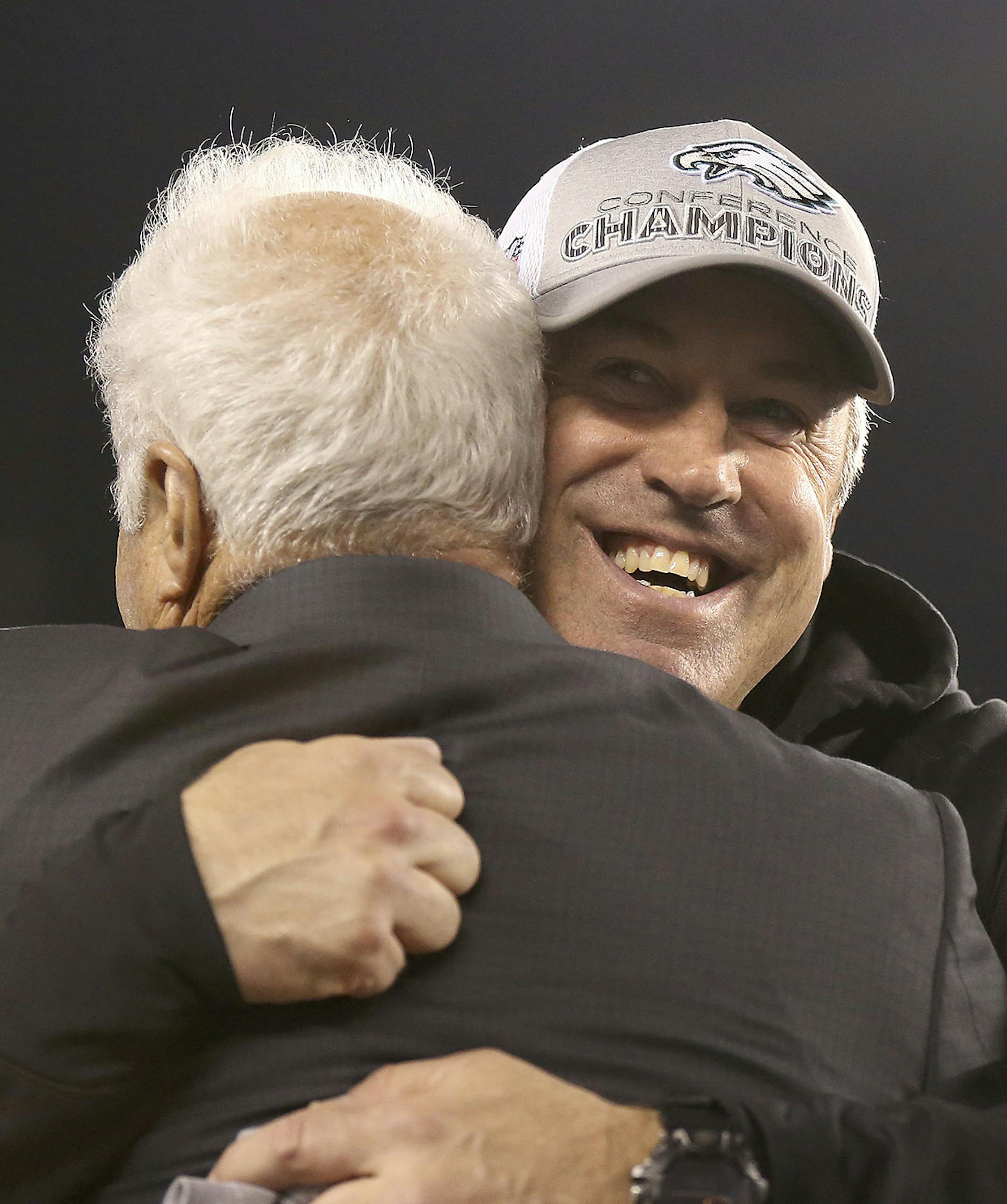 Philadelphia Eagles owner Jeffrey Lurie, left, and coach Doug Pederson hug after the team's 38-7 win over the Minnesota Vikings during the NFC championship NFL football game Sunday, Jan. 21, 2018, in Philadelphia. (David Maialetti/The Philadelphia Inquirer via AP)