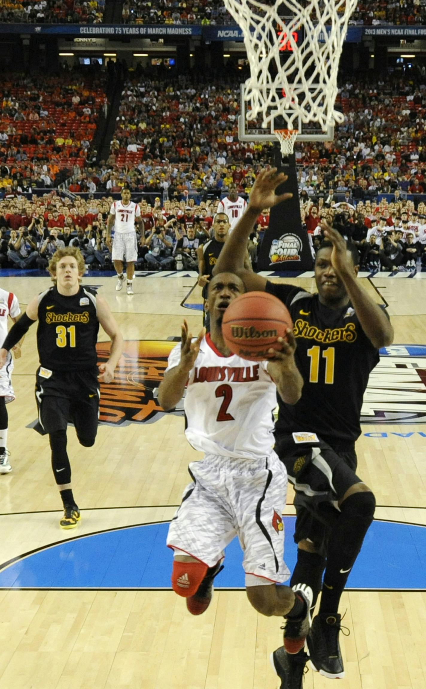 Louisville guard Russ Smith (2) drives the lane against Wichita State forward Cleanthony Early (11)duiring the a semi-final game in the NCAA Men's Basketball Championship at Georgia Dome in Atlanta, Georgia, Saturday, April 6, 2013. Louisville defeated Wichita State, 72-68. (Pool/Chris Steppig/NCAA Photos/MCT) ORG XMIT: 1137190