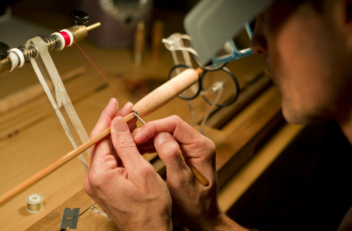 Larry P Donahe of Victoria who owns Split Cane Rods make high-end bamboo rods that are wrapped in silk thread. He is wrapping parts of the rod in silk thread. A rod can take 50 hours and cost upwards of $1800.]richard tsong-taatarii/rtsong-taataarii@startribune.com