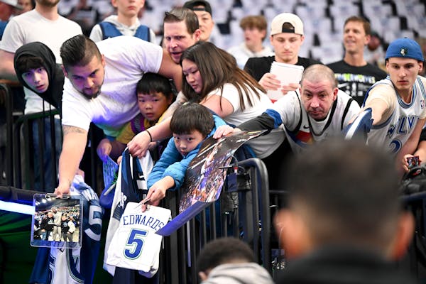 Fans vie for the attention of Timberwolves guard Anthony Edwards as he walked toward the locker room after warming up before Game 6.