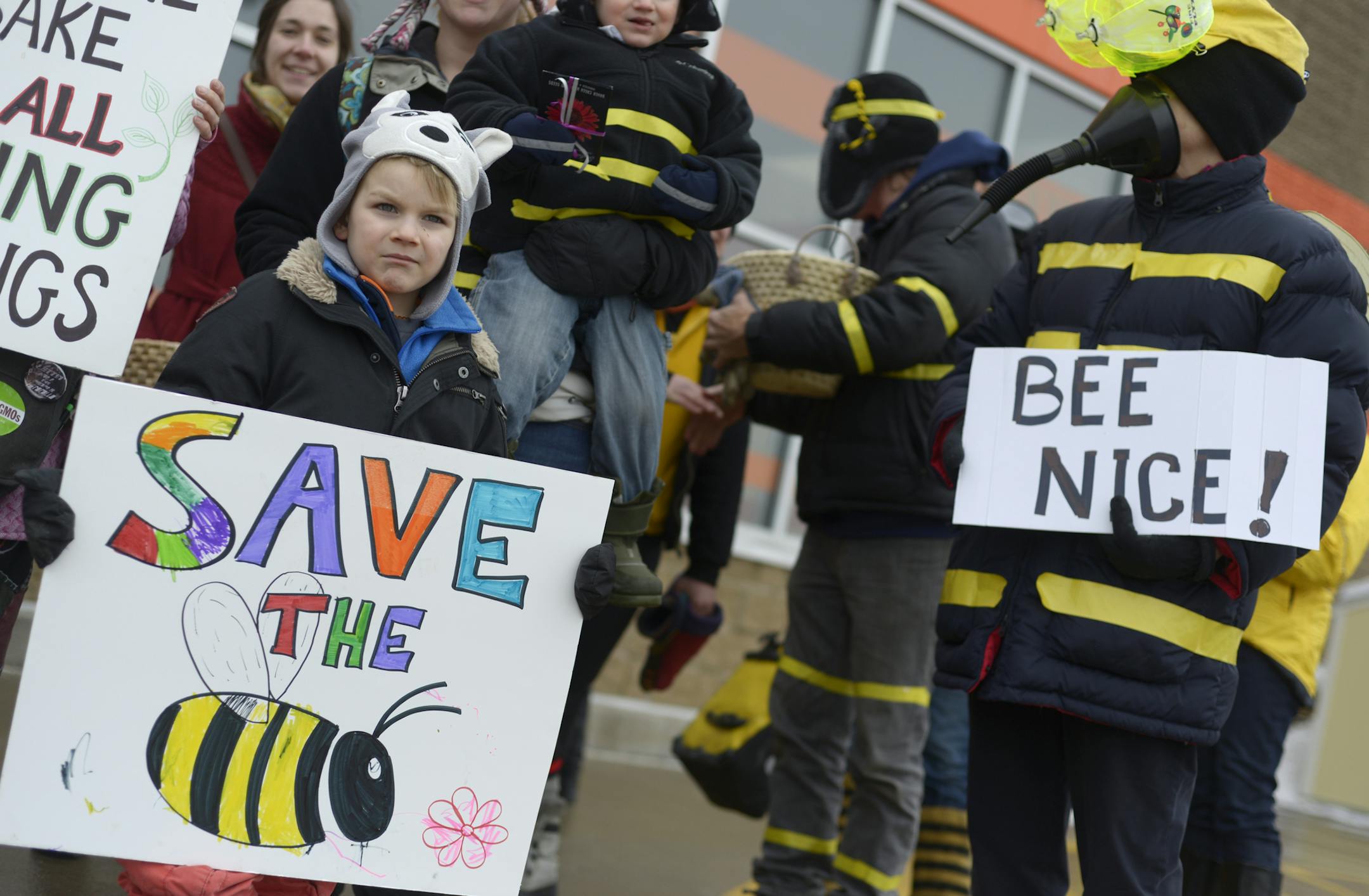 Max Wilhelm, 4, and Ruth Lindh protest at Home Depot in Minneapolis, asking the company to stop selling pesticides that research has shown is harming bees on Wednesday February 12, 2014. ] (AMANDA SNYDER/ Special to the Star Tribune)