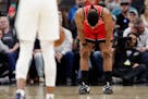 Toronto Raptors guard Kyle Lowry (7) holds his head down as players stop the action o.f a basketball game during the first half against the San Antoni