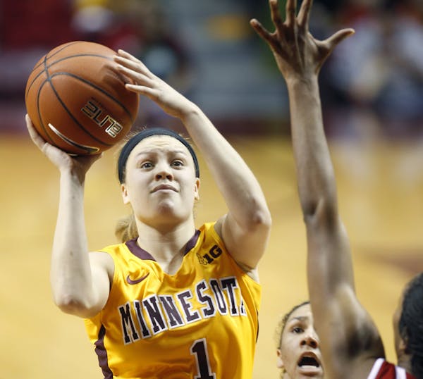 Minnesota's Rachel Banham went up to score two of her 19 game points despite Wisconsin's defense in the second half as the Minnesota Gophers took on t