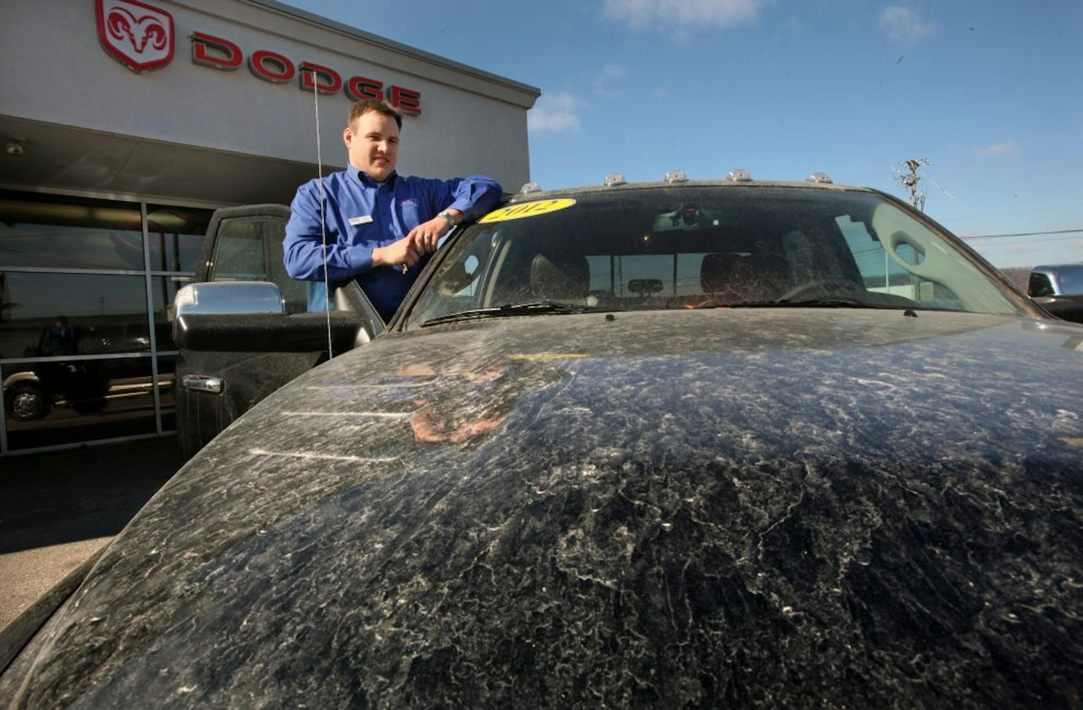 Nowhere are the concerns about sand mining, and expectations for its economic potential, more palpable than in the town of Winona. It's also becoming a lesson in how communities cope with a new industry that is booming in lock step with the business it supplies – the controversial oil and gas drilling practice called hydro fracking. (IN THIS PHOTO) Andrew Puetz, General Manager of Chrysler Winona, just a couple blocks from the giant frac sand pile in downtown Winona, has found dust particles adh